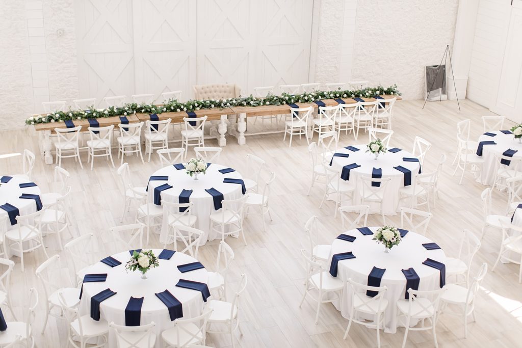 circle tables with navy napkins at The Nest at Ruth Farms