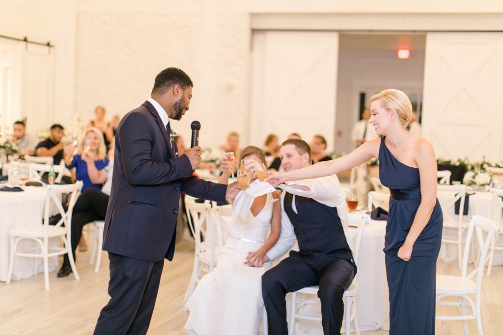 newlyweds toast with best man and maid of honor