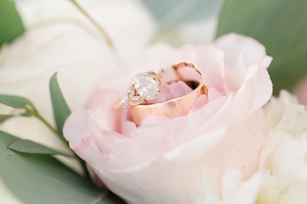 bride's ring rests on pink flower