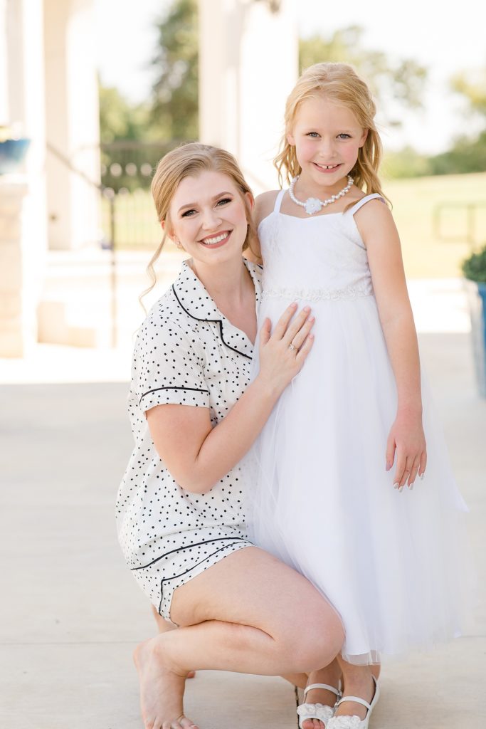 bride poses with flower girl