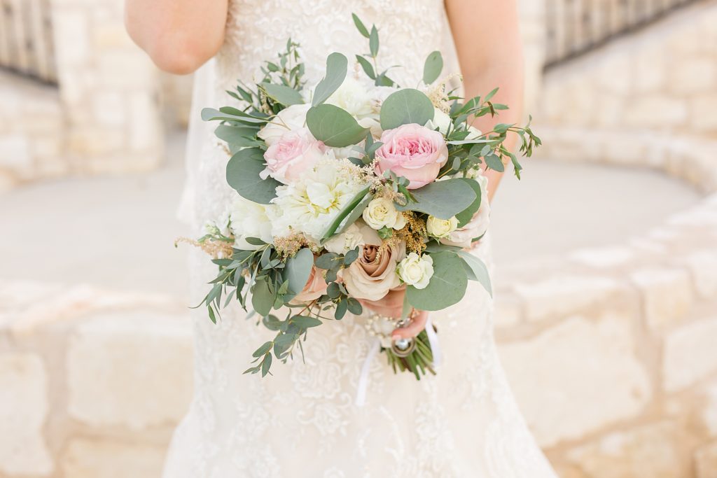 bride holds bouquet with pink and white flowers
