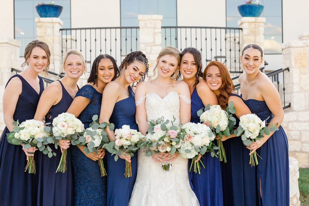 Texas bridesmaids smile with bride