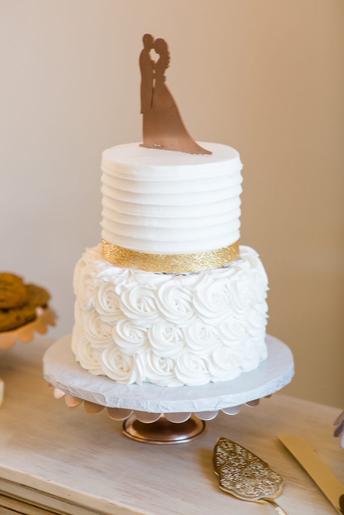 tiered wedding cake with gold banner 