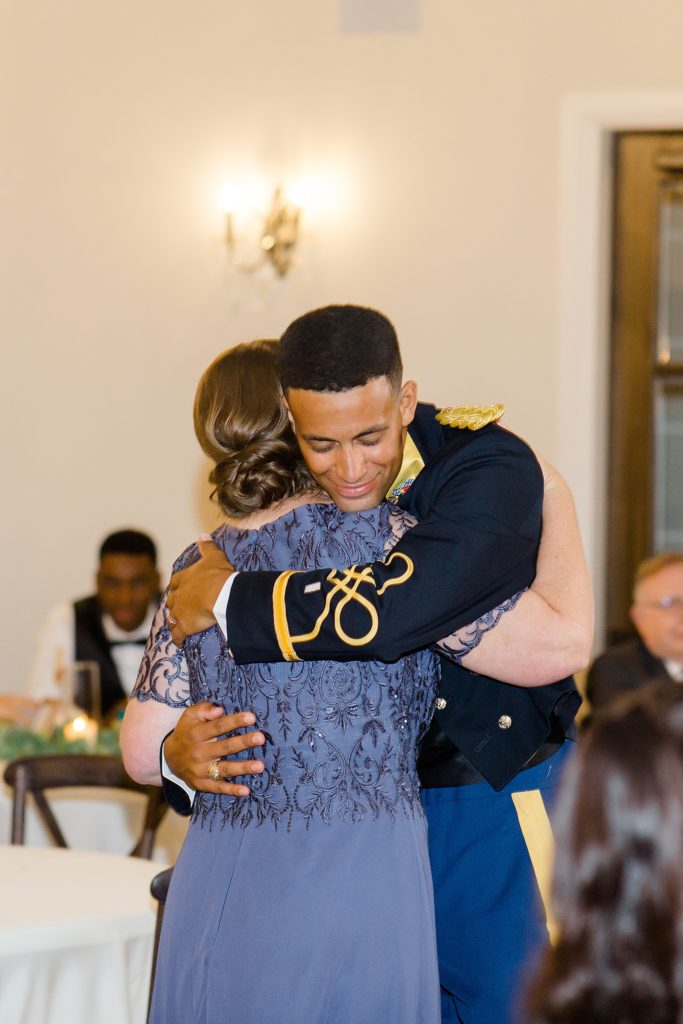 groom hugs mom after dance at wedding reception