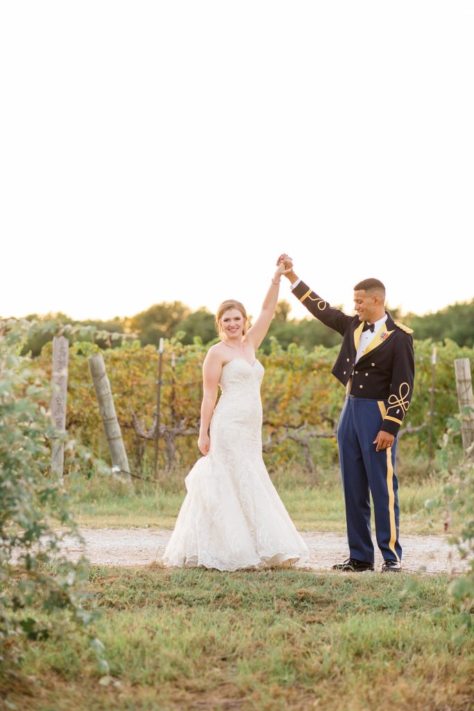 groom in military dress twirls bride