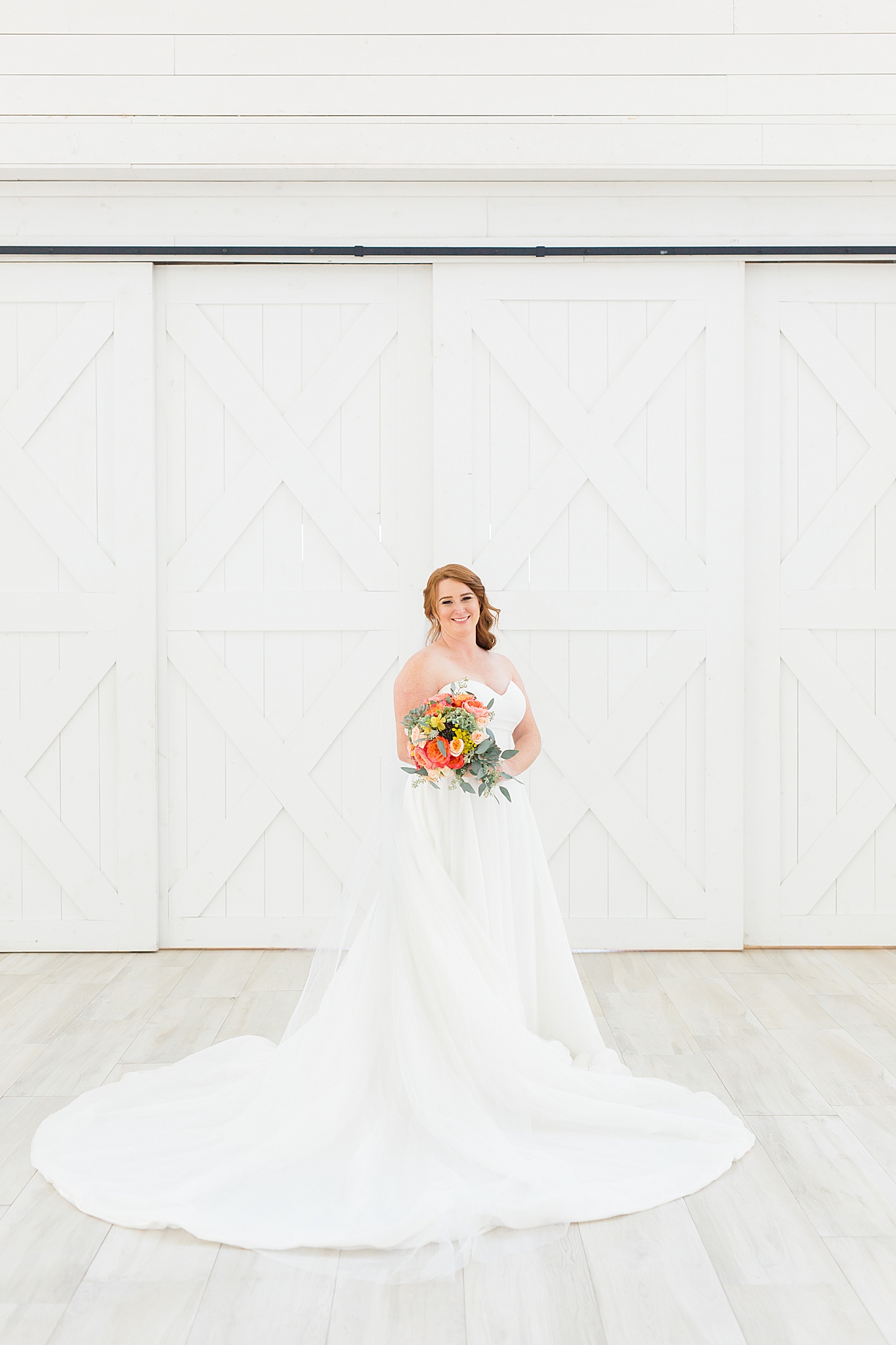 bride holds bouquet in arms during The Nest at Ruth Farms bridal session