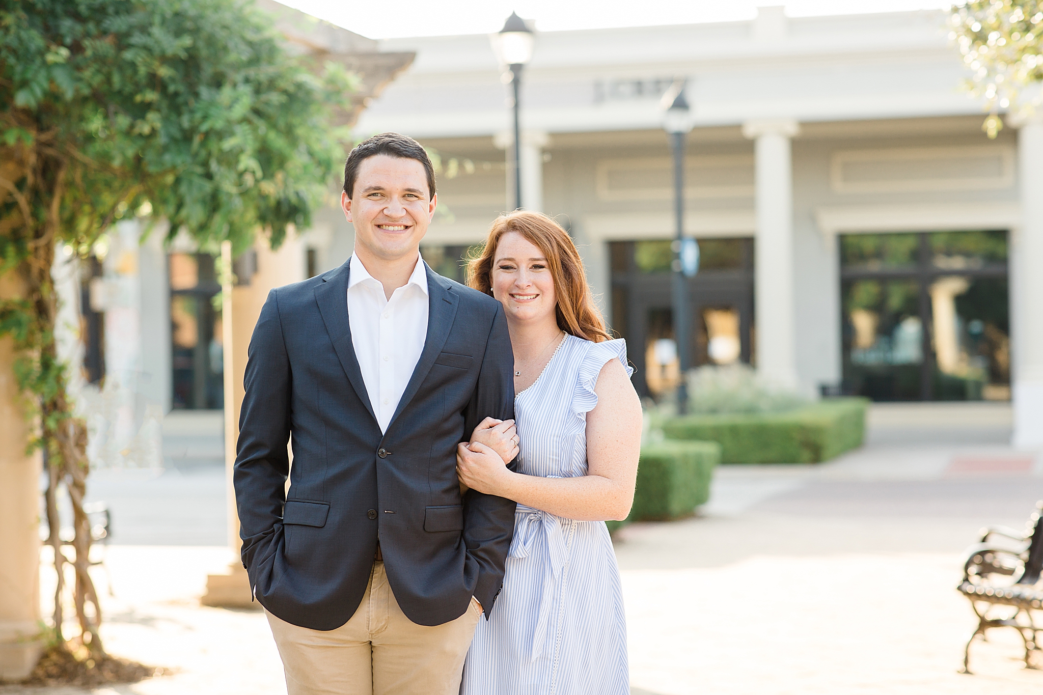 couple poses in town square during Southlake TX engagement session