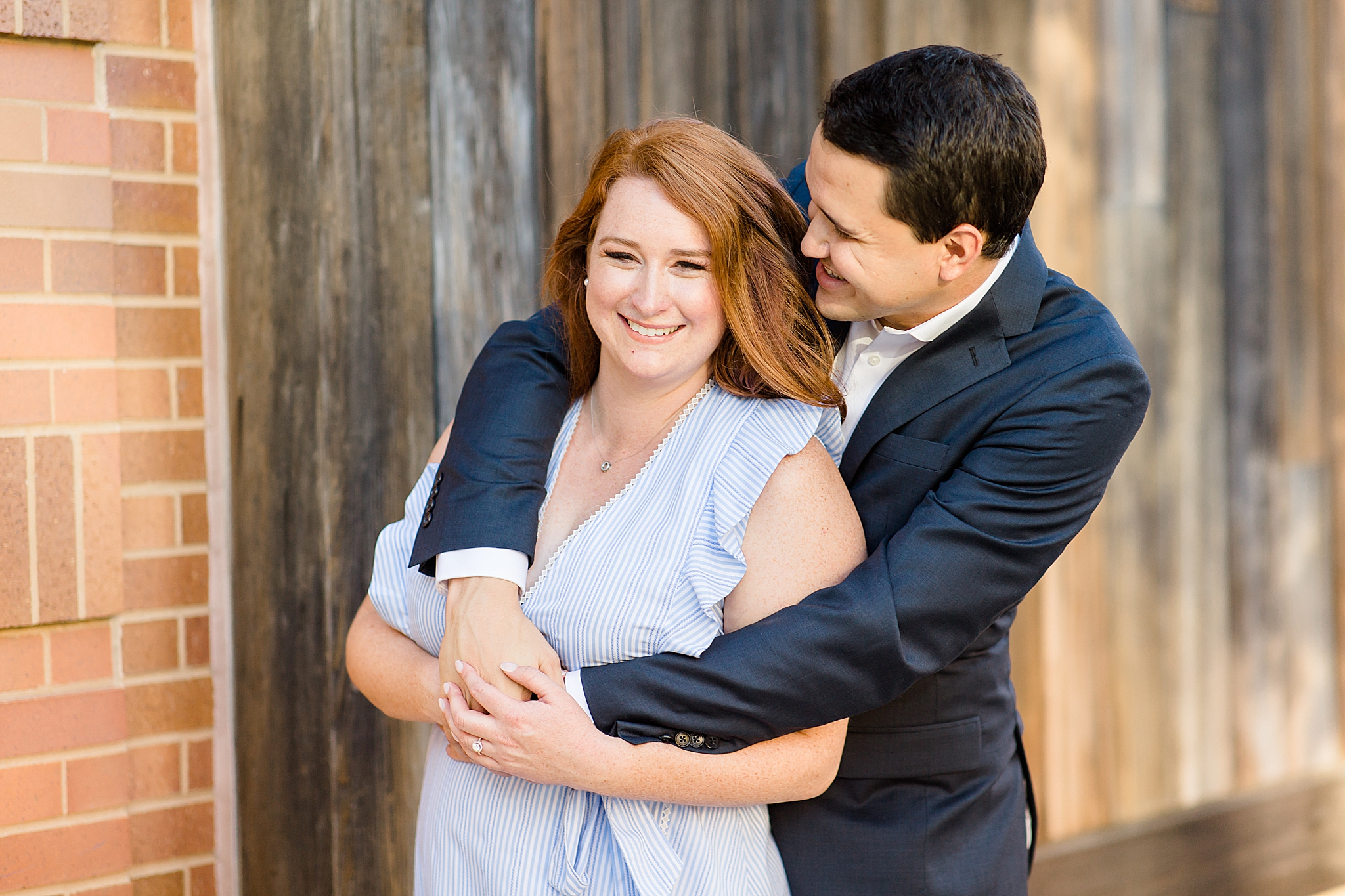 couple hugs during Southlake Town Square engagement photos