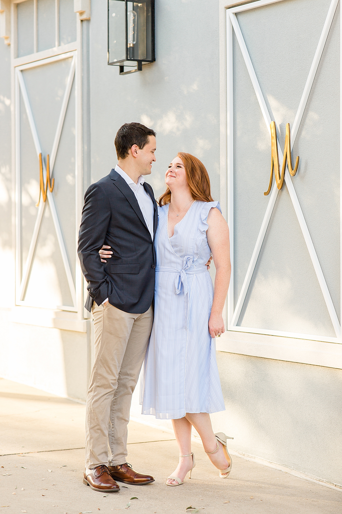 bride and groom look at each other during Southlake Town Square engagement photos