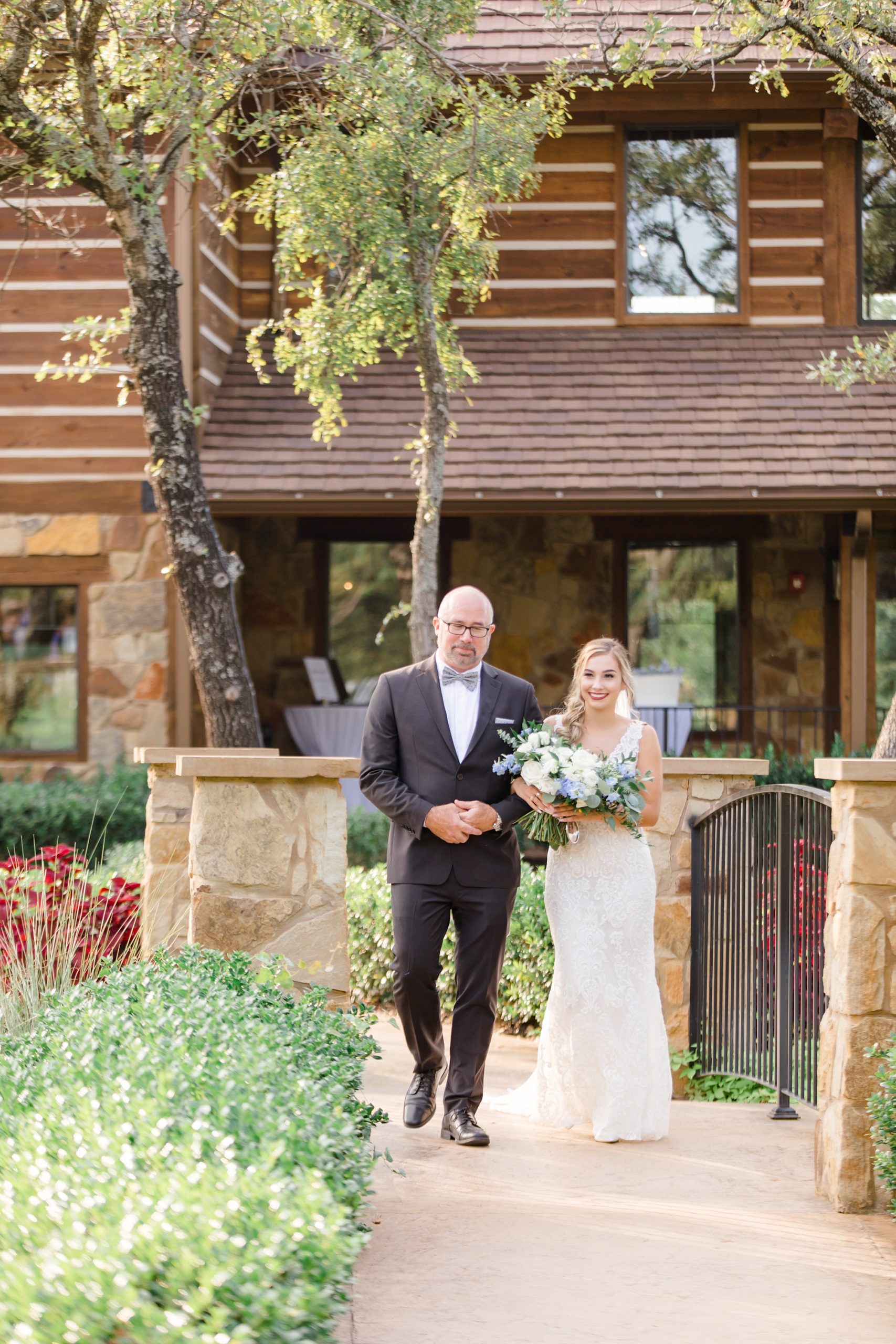 bride and father walk down aisle at The Lodge