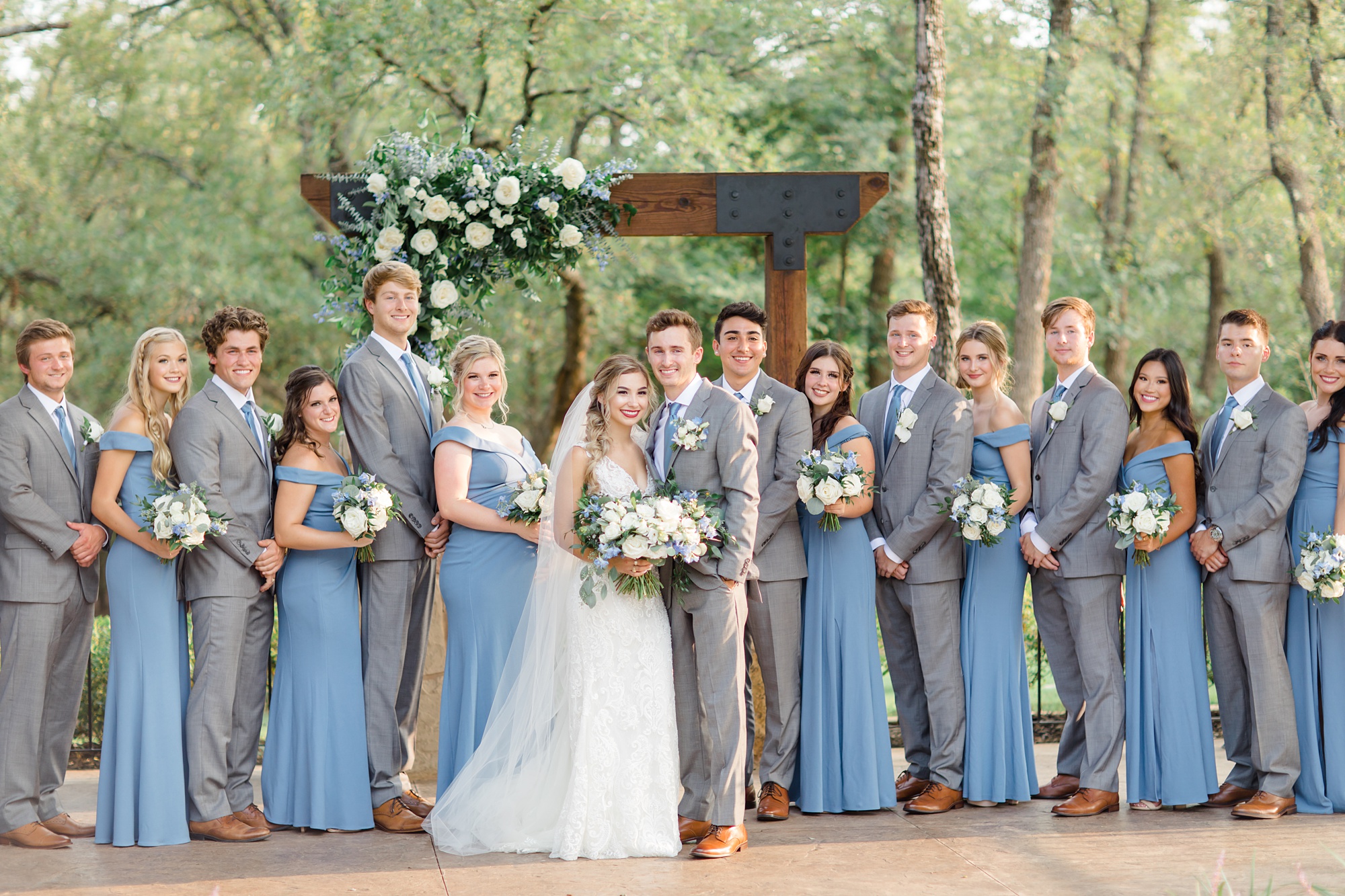 bride and groom pose with bridal party at The Lodge