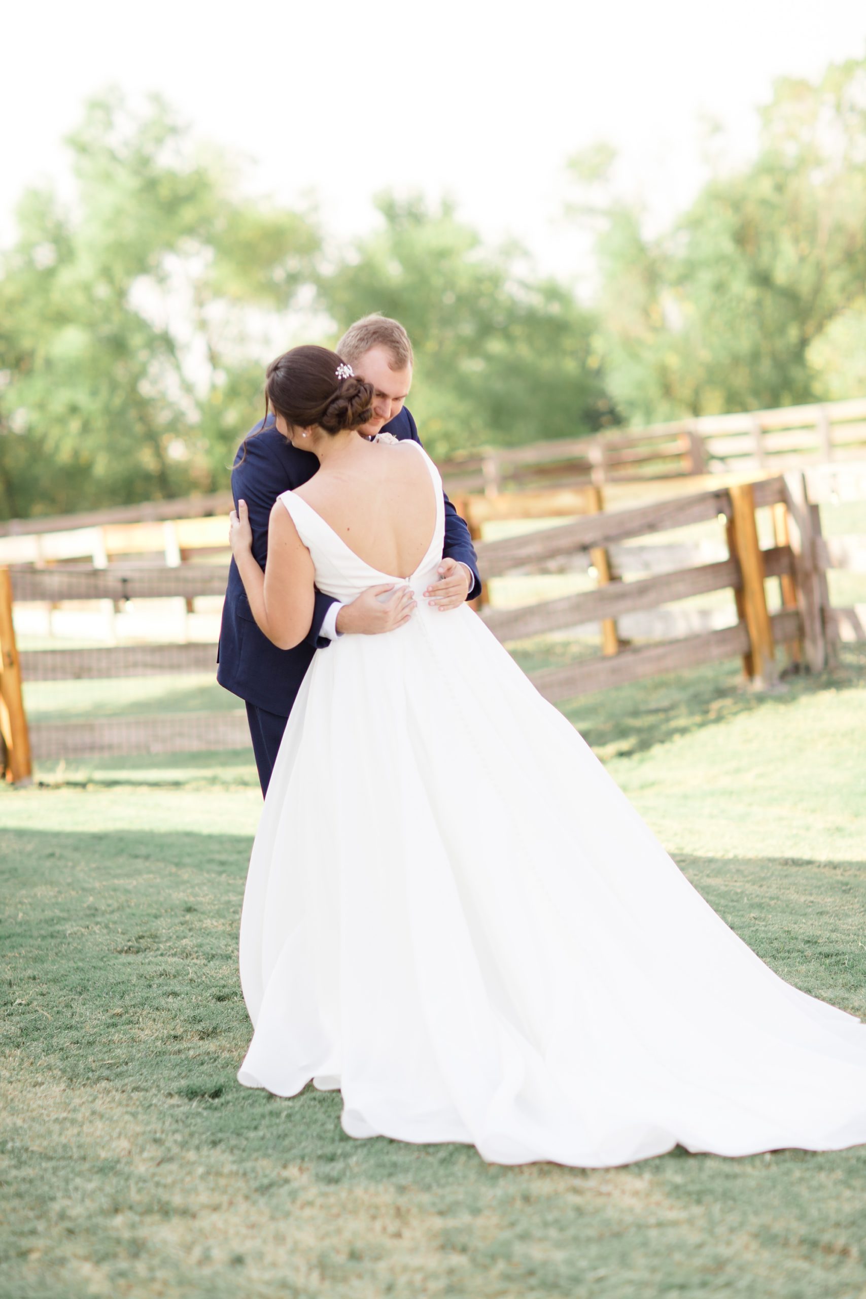 bride and groom hug during first look on family ranch