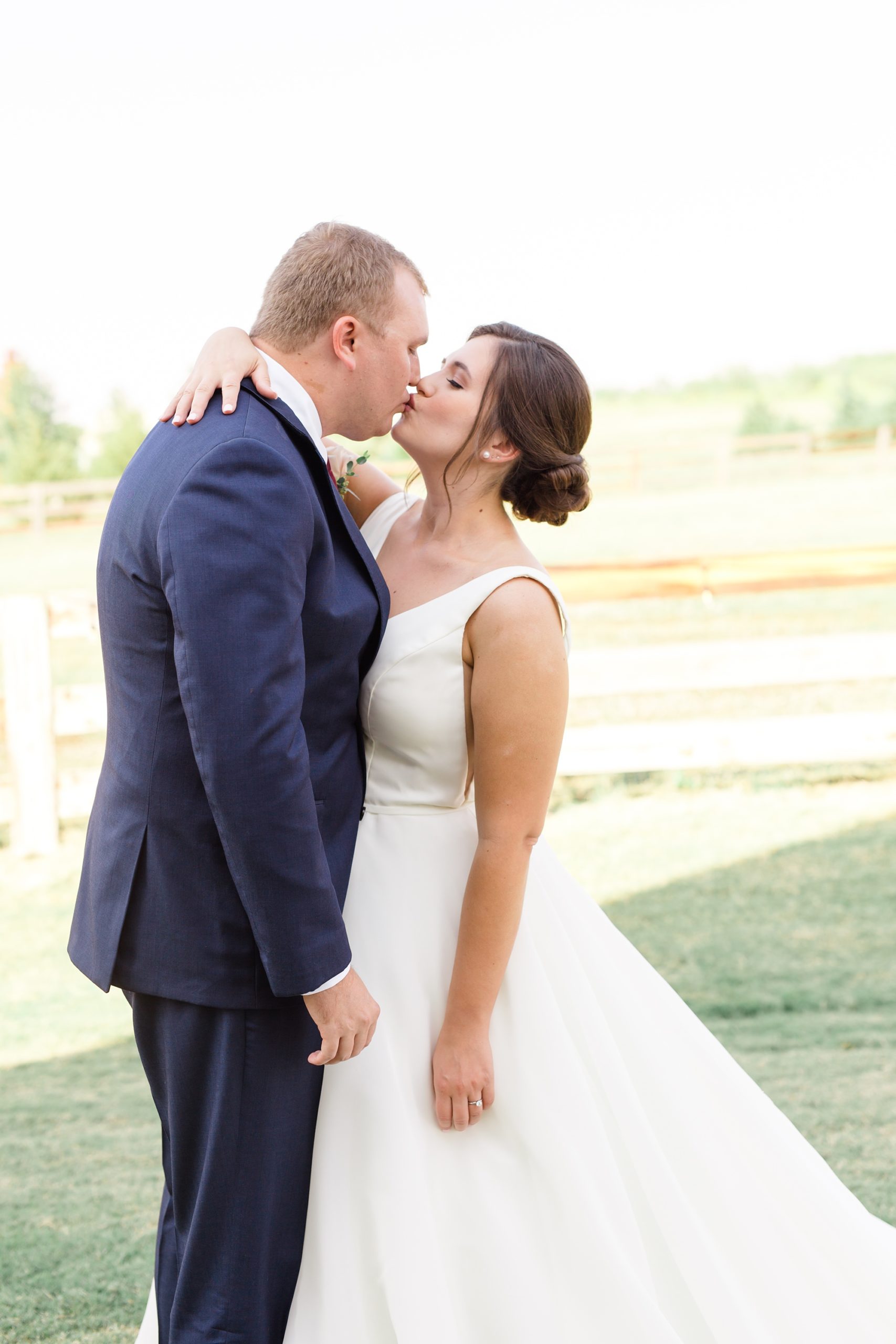 bride and groom kiss during first look
