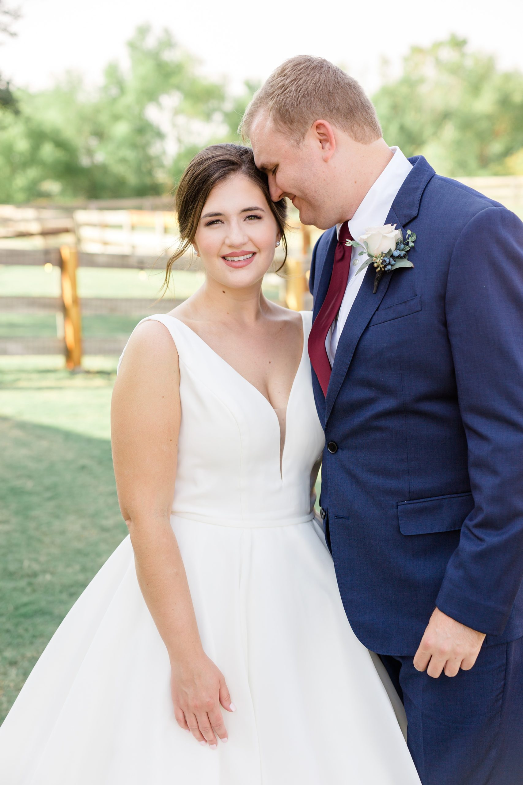 groom nuzzles bride's forehead during wedding photos