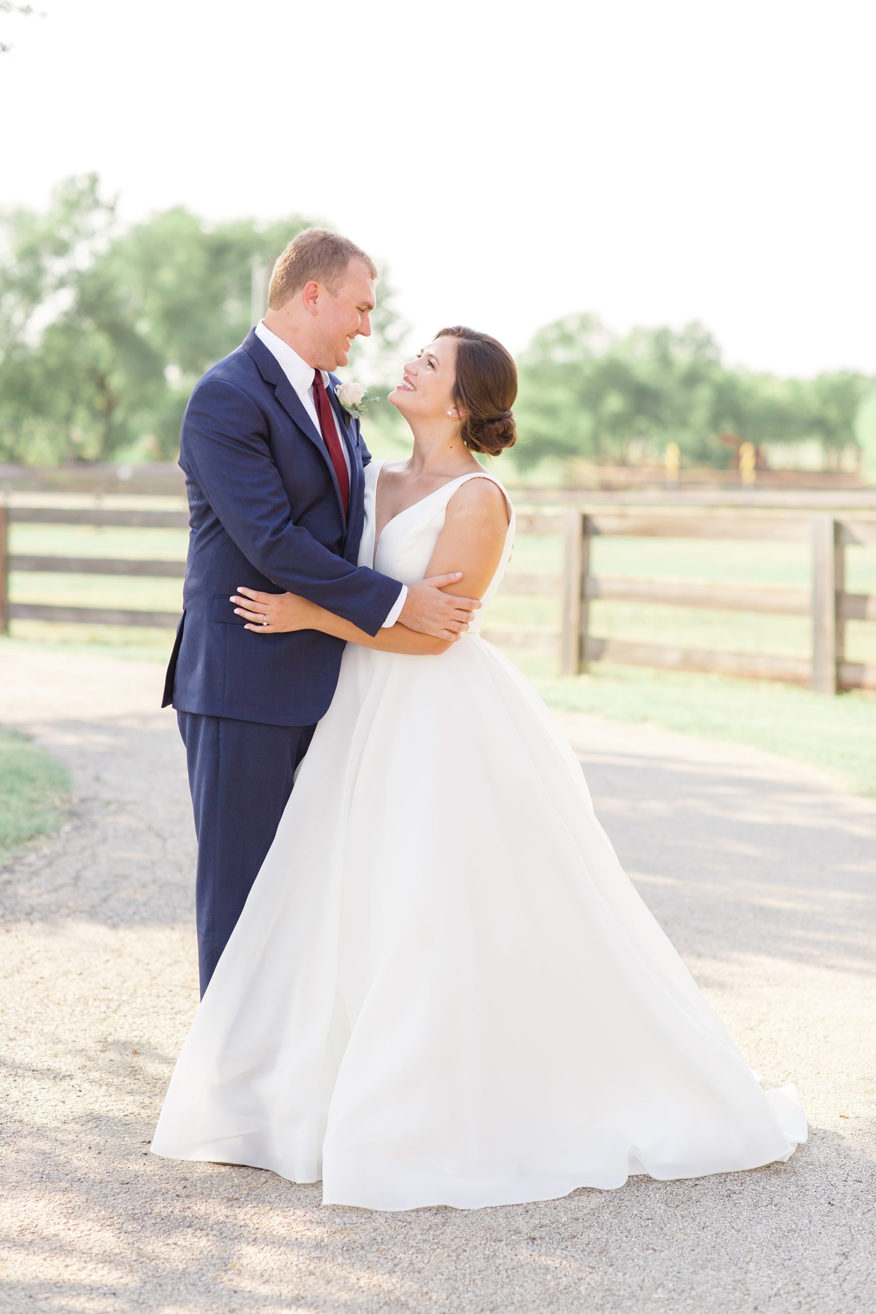 newlyweds in Argyle TX pose on driveway