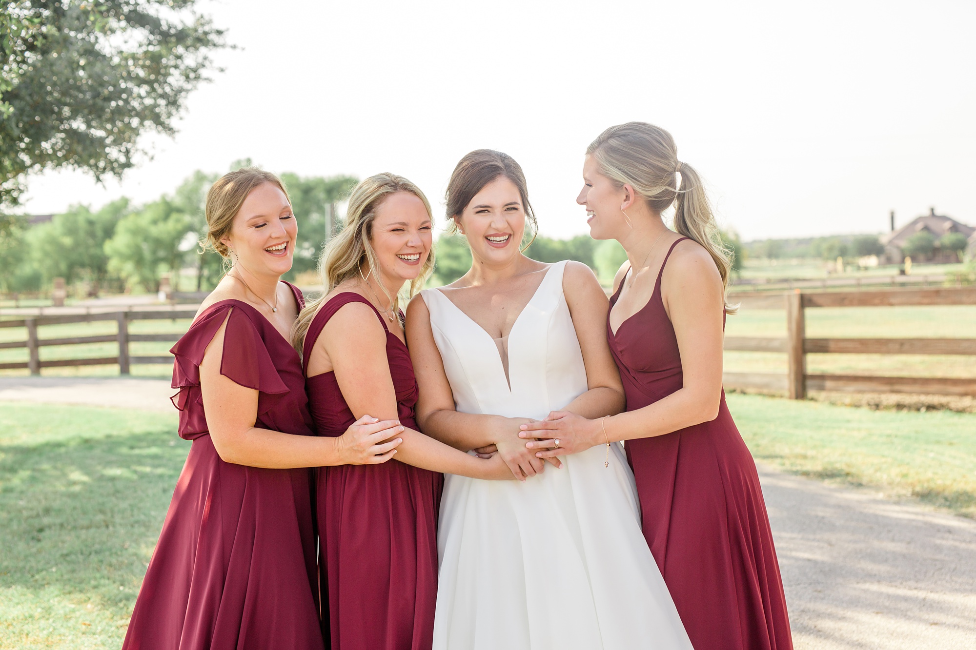 bridesmaids hug bride during private ranch wedding in Texas