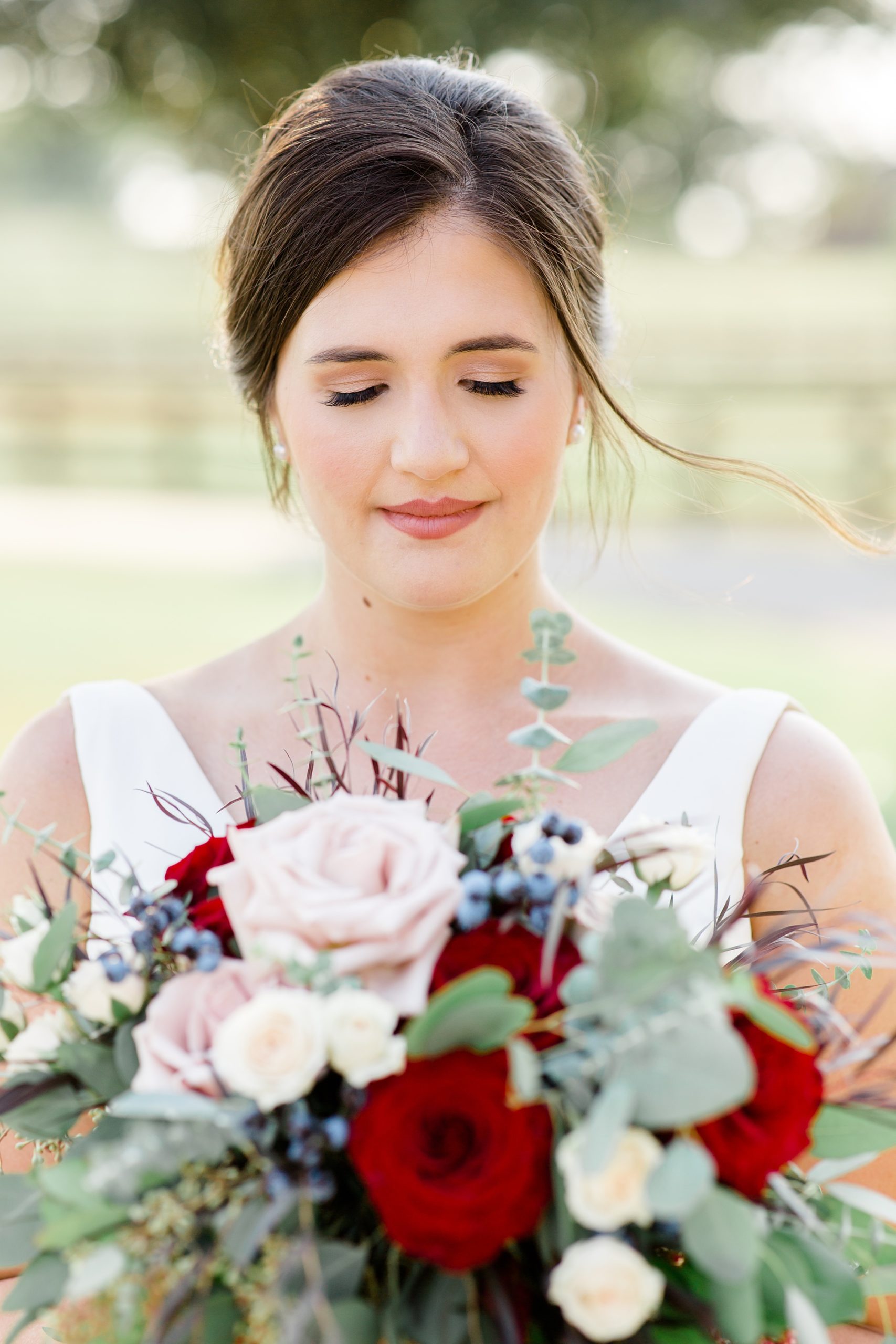 bride holds bouquet and closes eyes