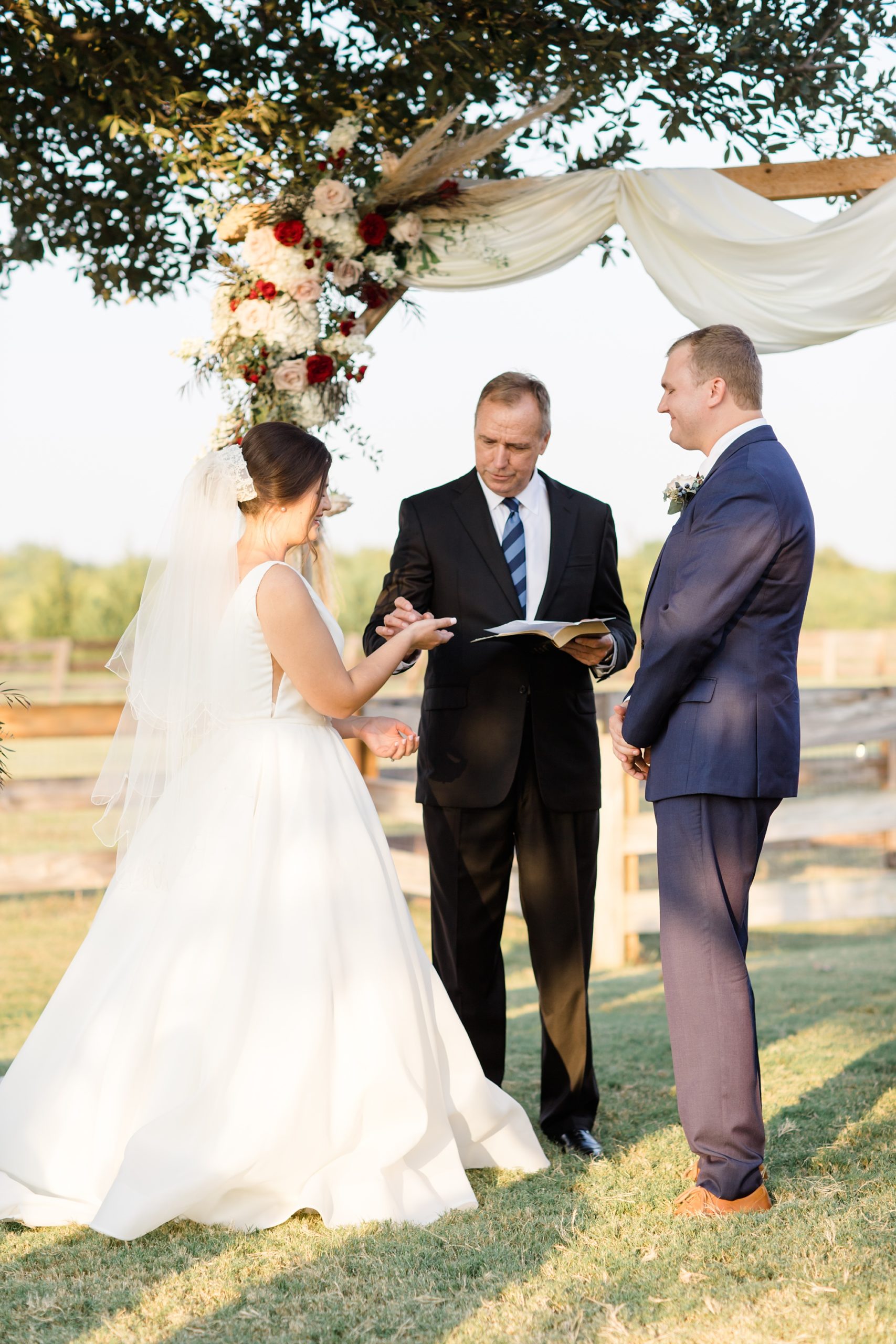 bride and groom exchange rings during Argyle TX wedding