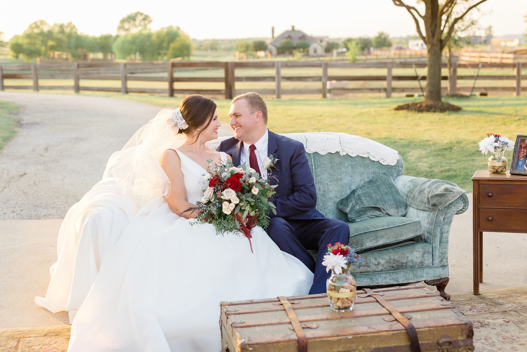 newlyweds sit on couch during Texas wedding reception