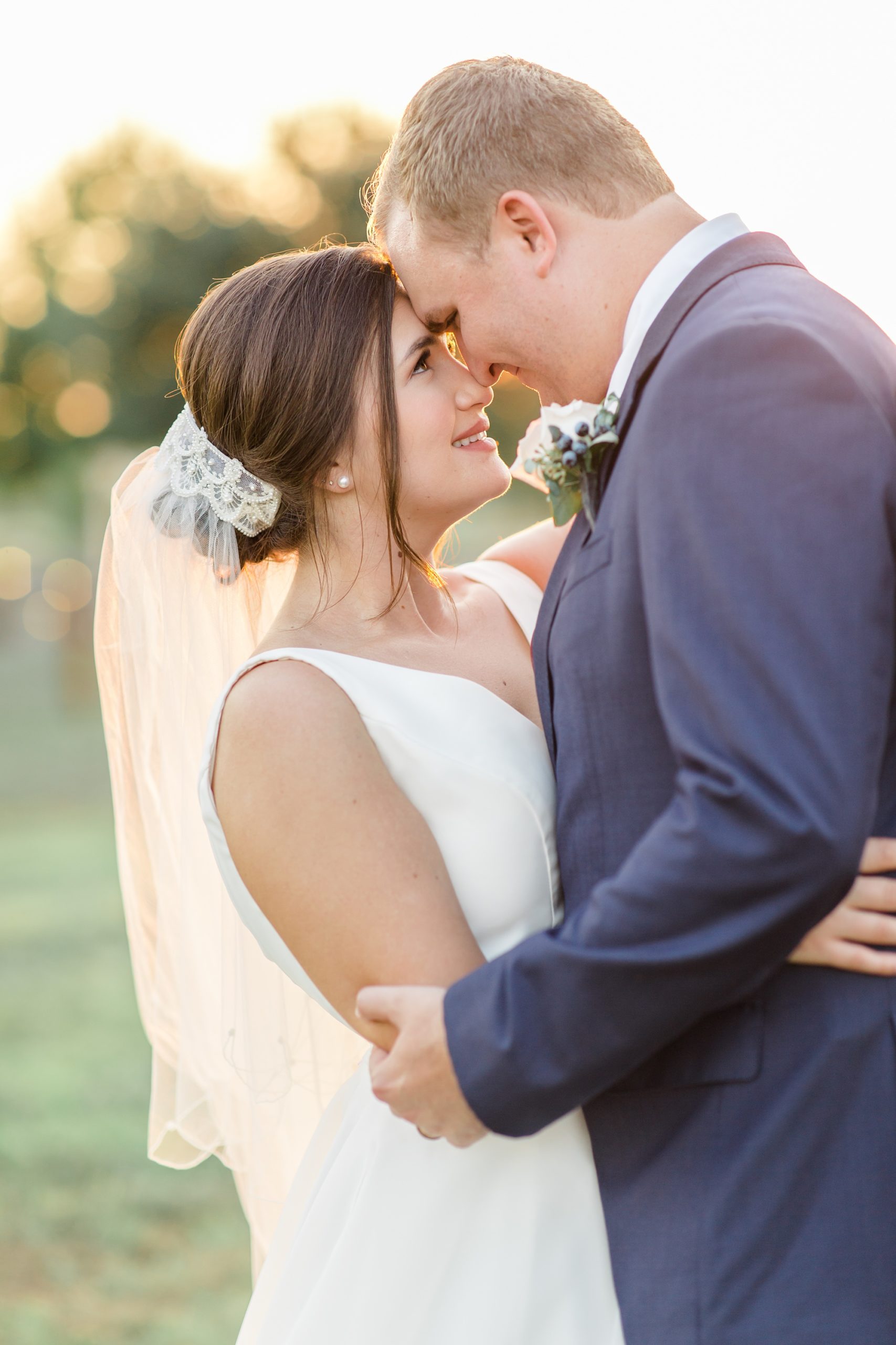 newlyweds stand nose to nose during Argyle TX wedding photos