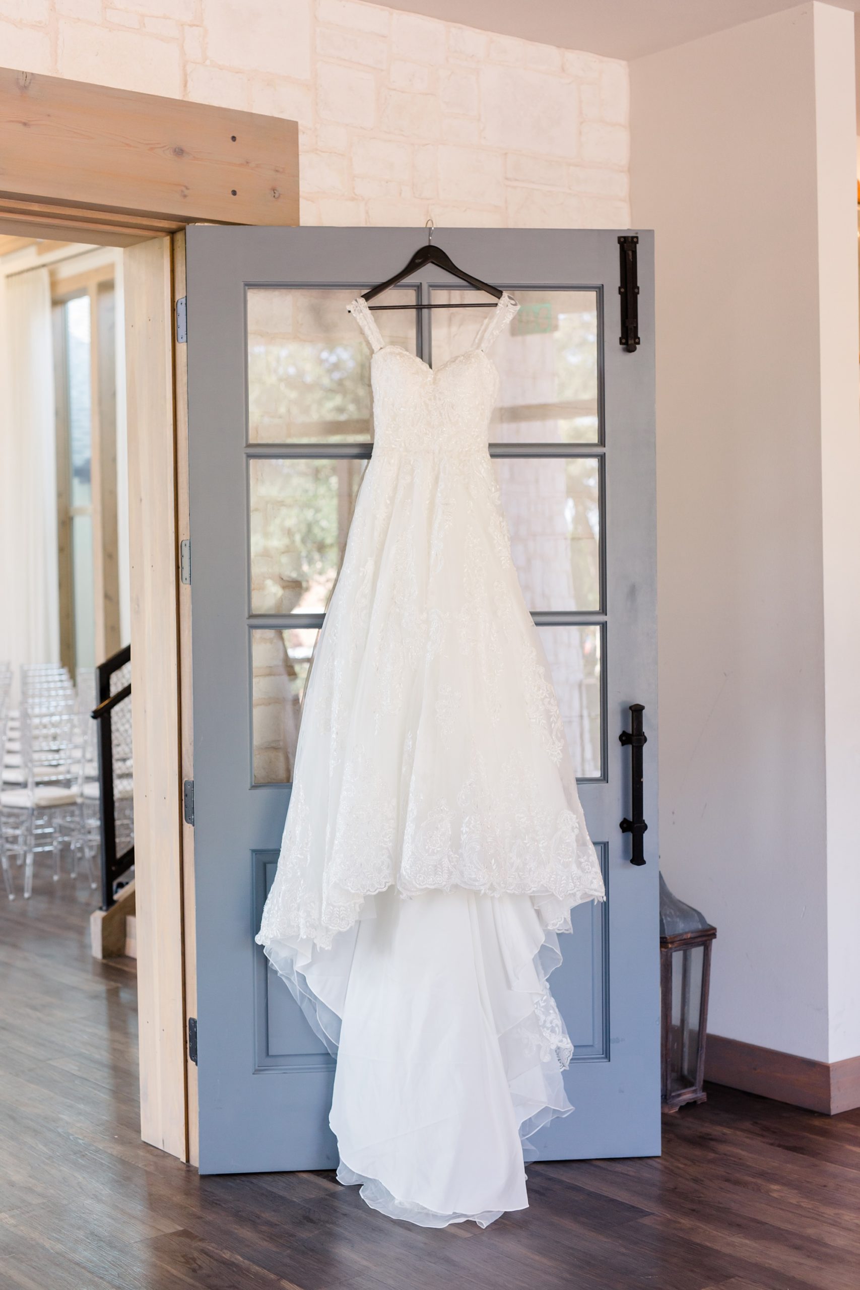 wedding dress hangs on doors at Hidden Pines Highland Village