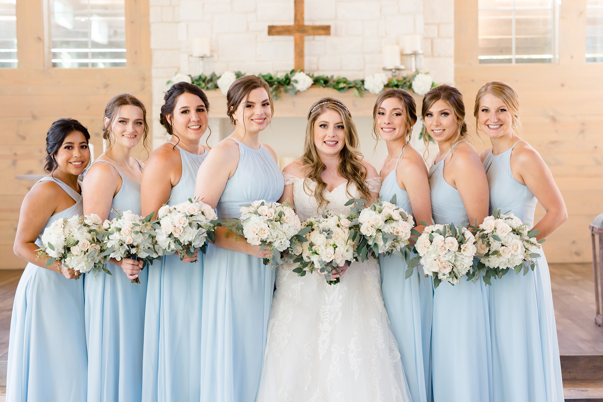 bridesmaids in sky blue gowns pose at Hidden Pines Highland Village
