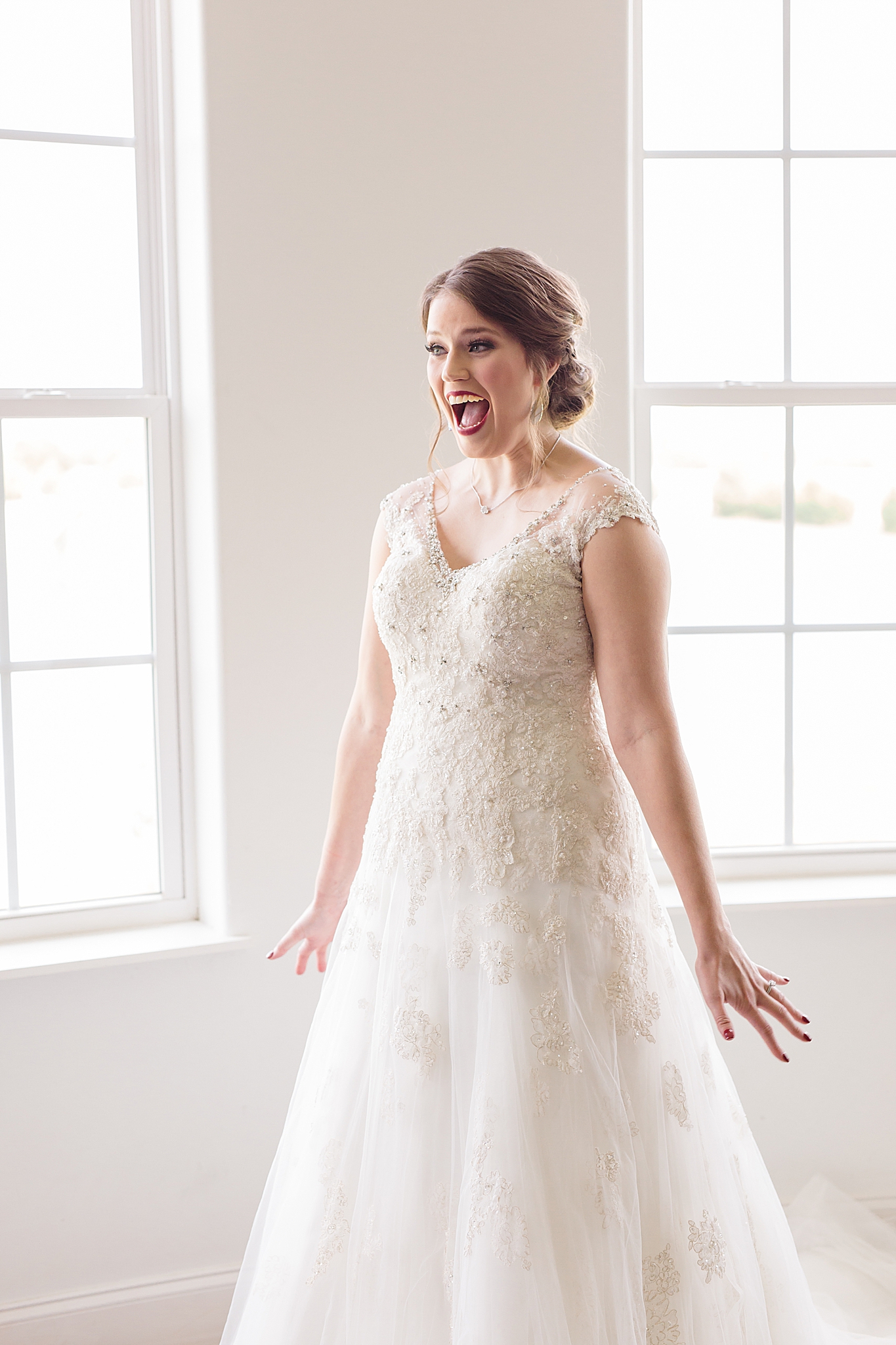 bride shows off wedding dress during first look