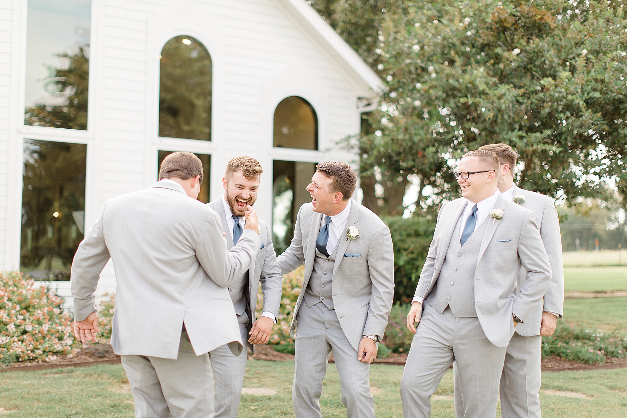 groomsmen goof off before Rustic Grace Estate wedding