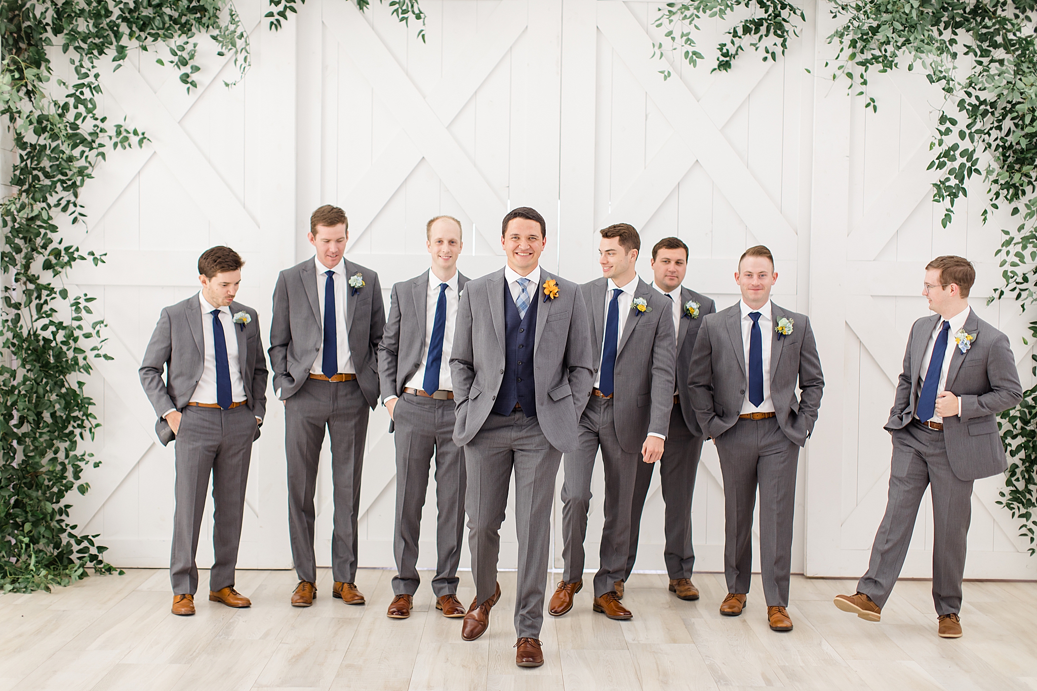 groom walks with groomsmen before The Nest at Ruth Farms wedding