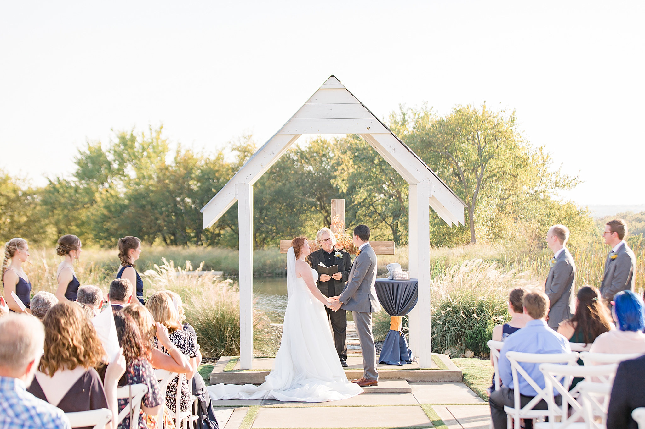 bride and groom exchange vows during outdoor wedding ceremony in Dallas