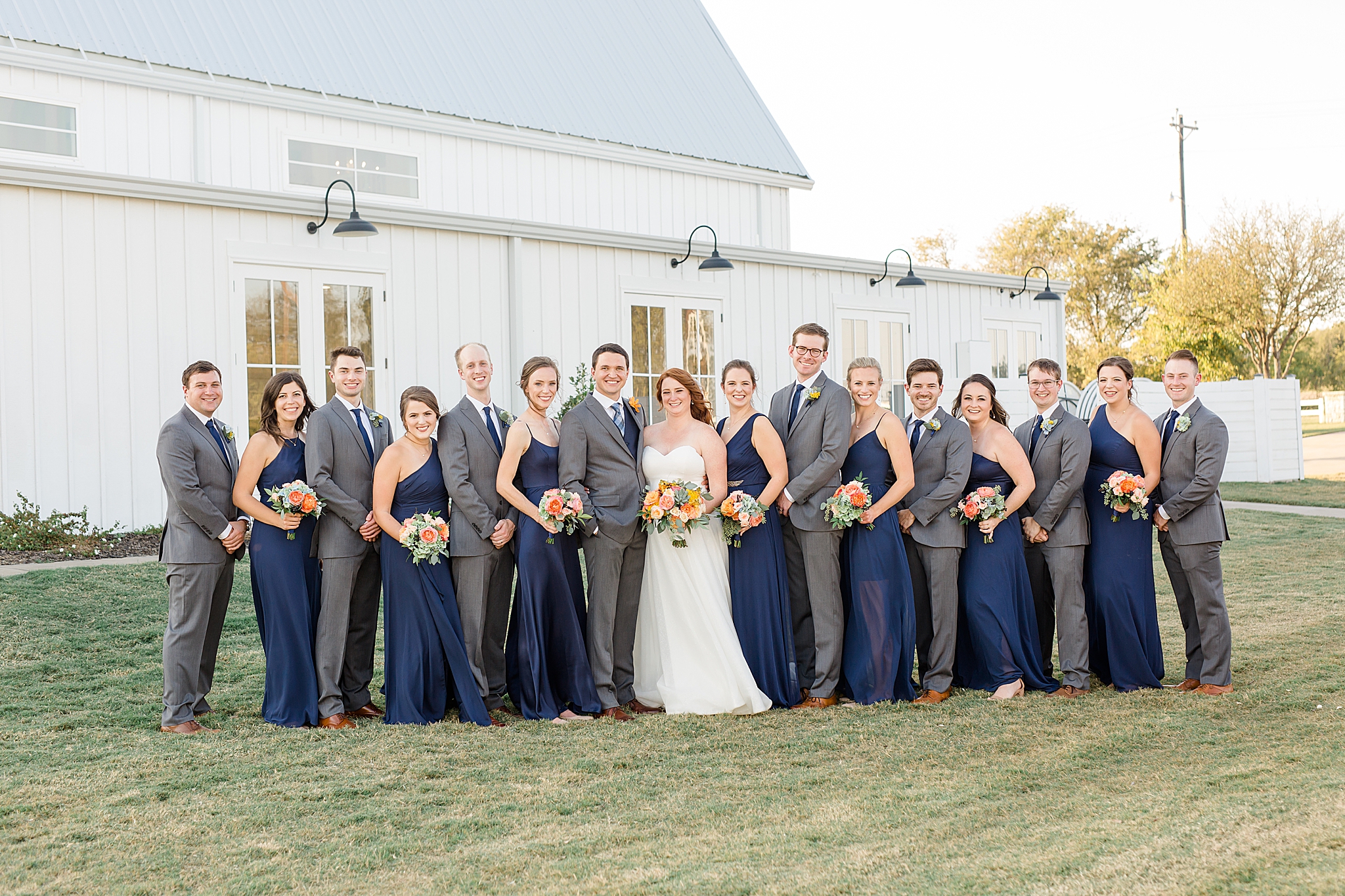 wedding party poses outside The Nest at Ruth Farms