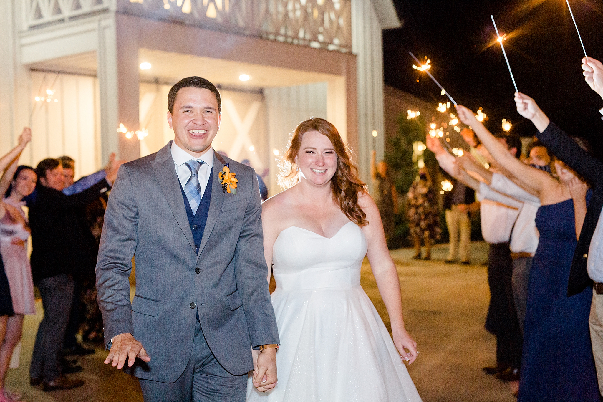 bride and groom leave during sparkler exit from Nest at Ruth Farms wedding reception