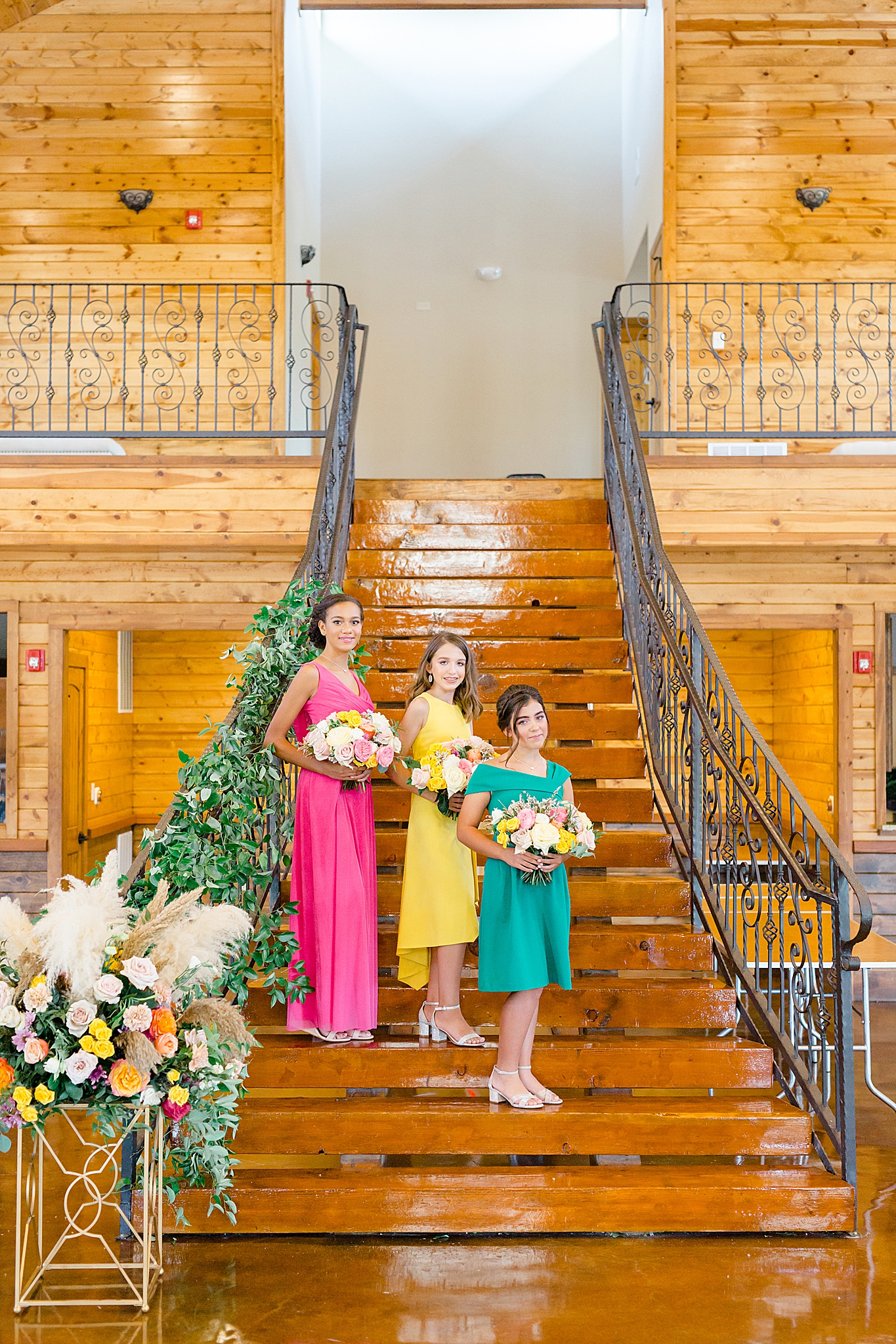 three Jr. bridesmaids stand on stairs at Hidden Creek Events