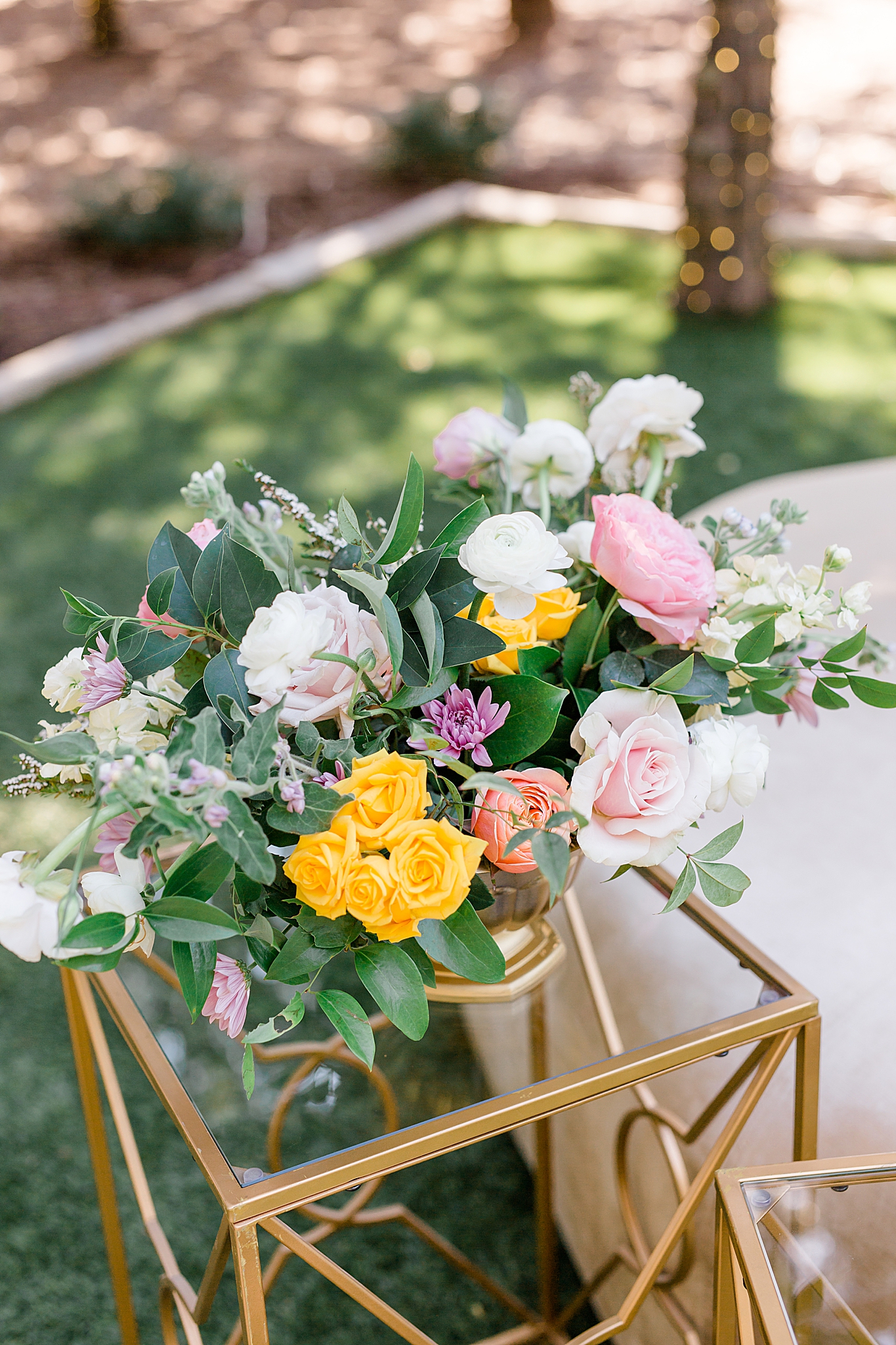 floral display on glass and gold table in Texas
