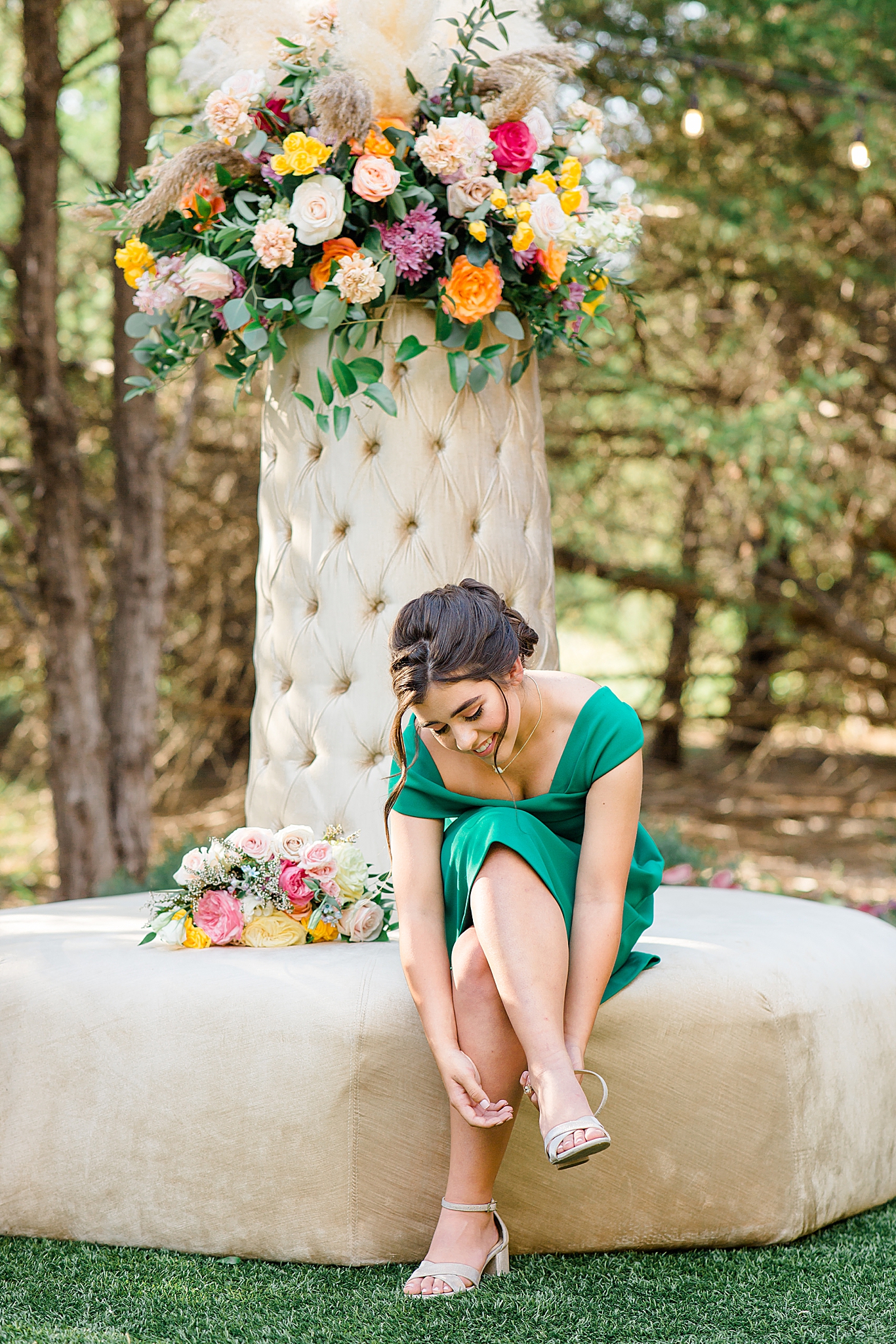 jr. bridesmaid in green gown adjusts shoes
