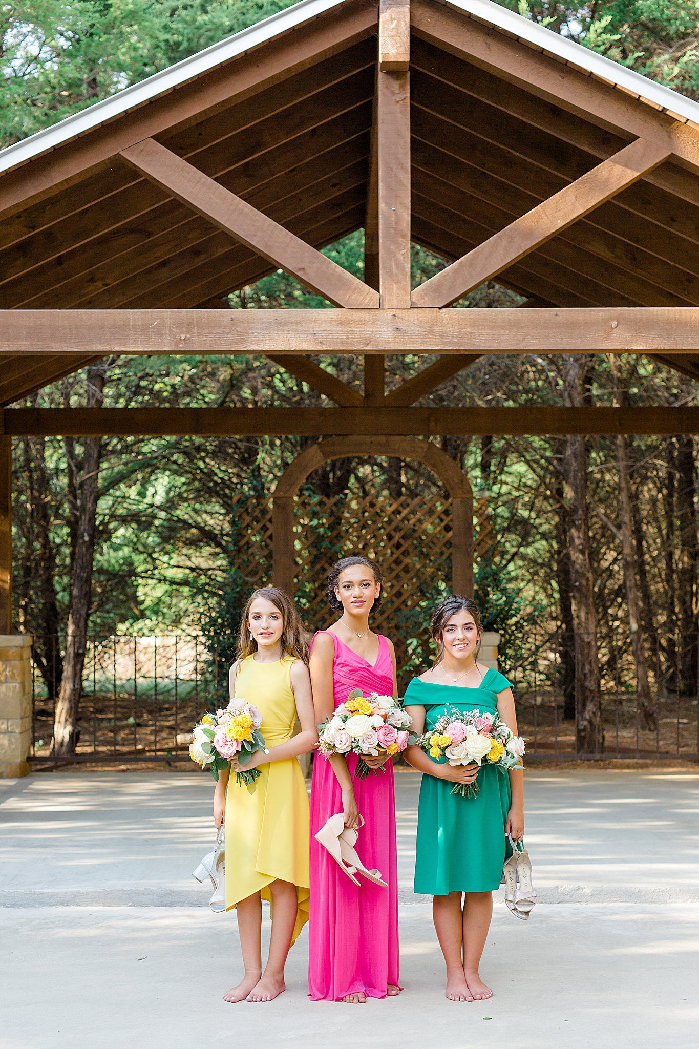 bridesmaids hold shoes at Hidden Creek Events