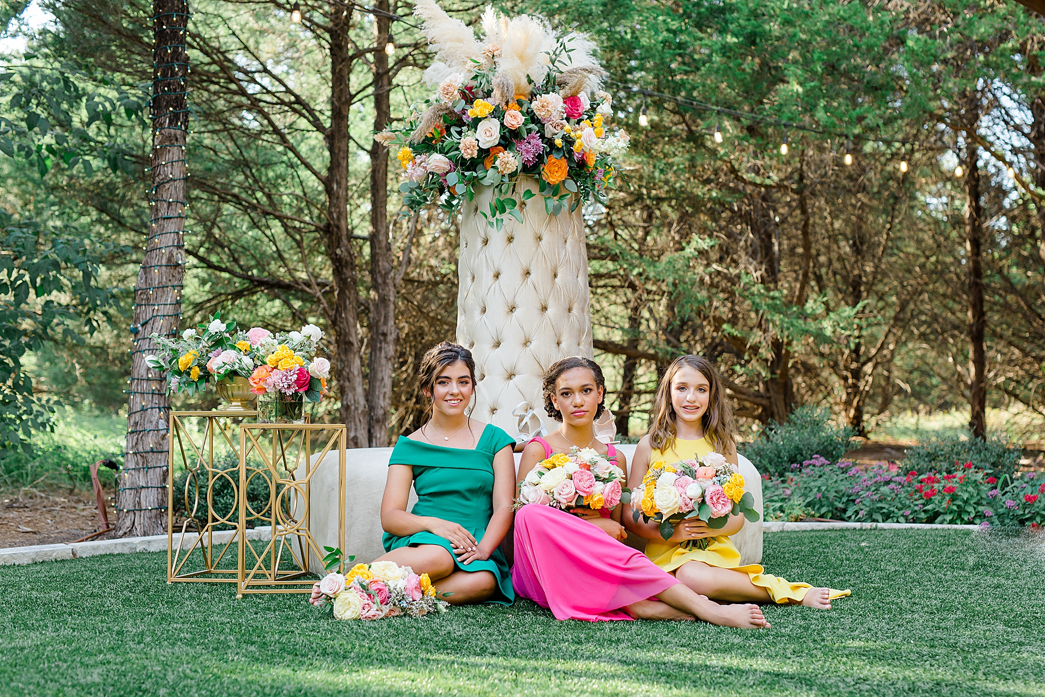 Junior Bridesmaids Styled Shoot with three girls by sofa floral display