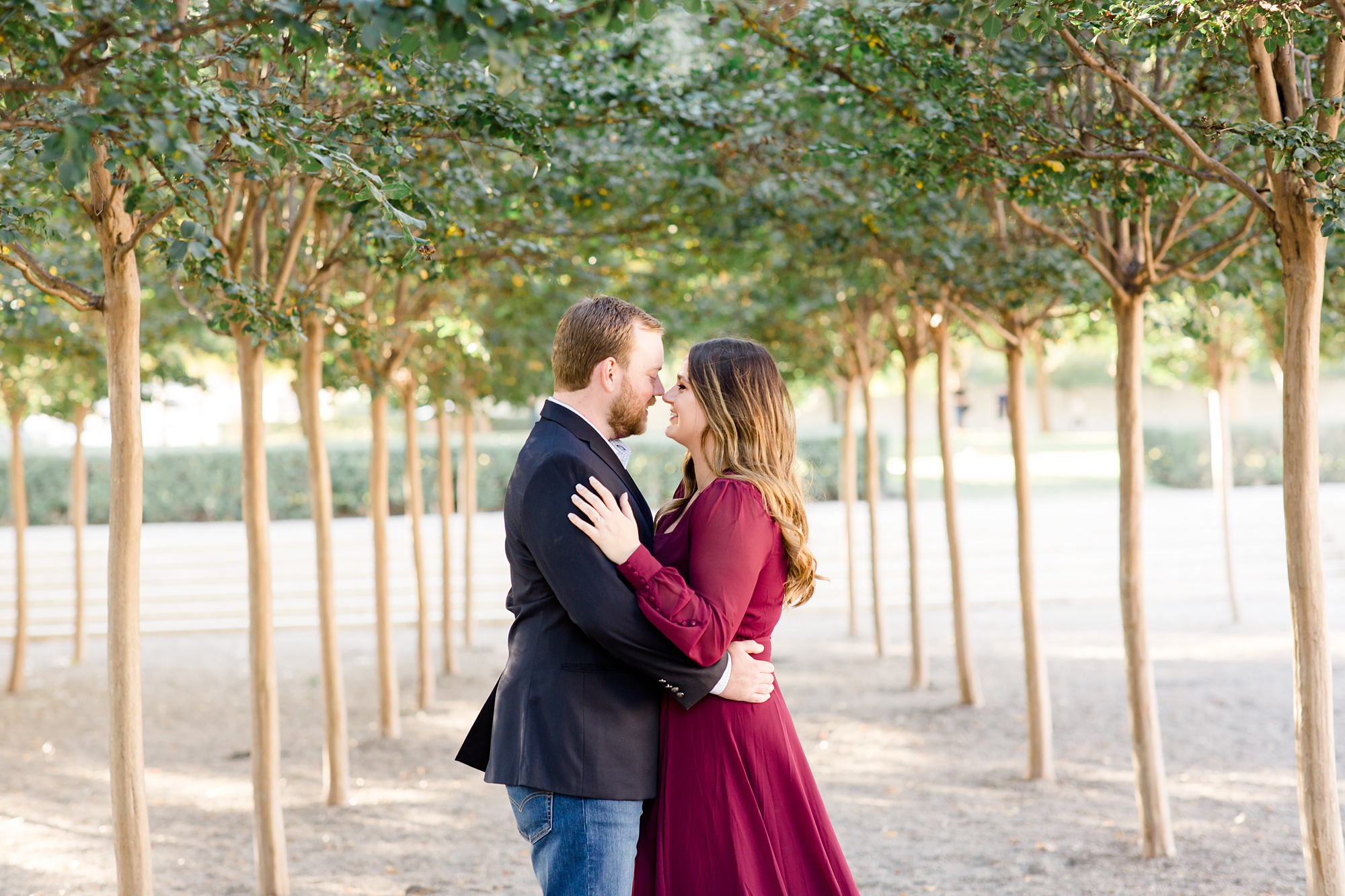 engaged couple poses in courtyard at Kimball Art Museum