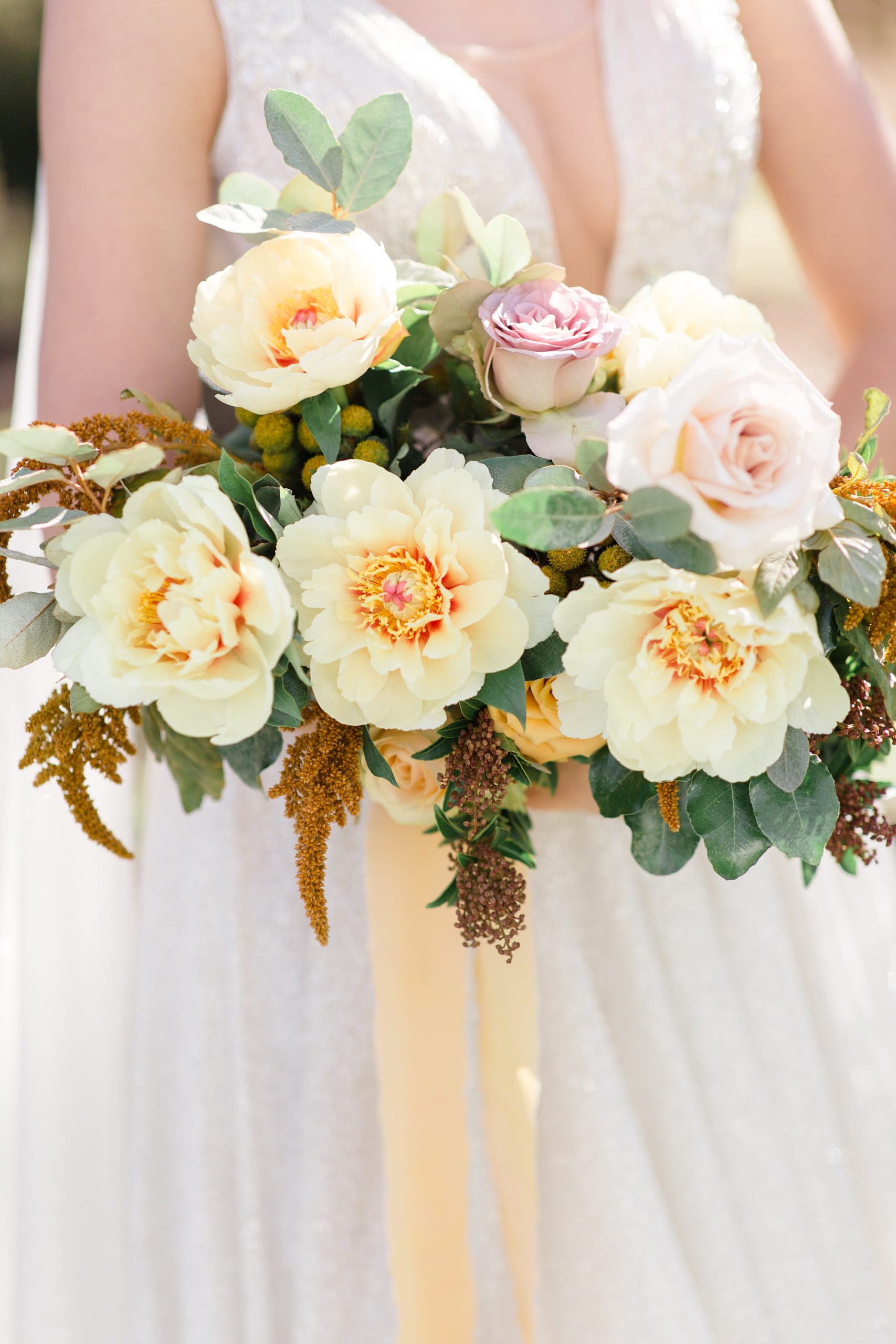 bridal bouquet with yellow flowers and peach ribbon