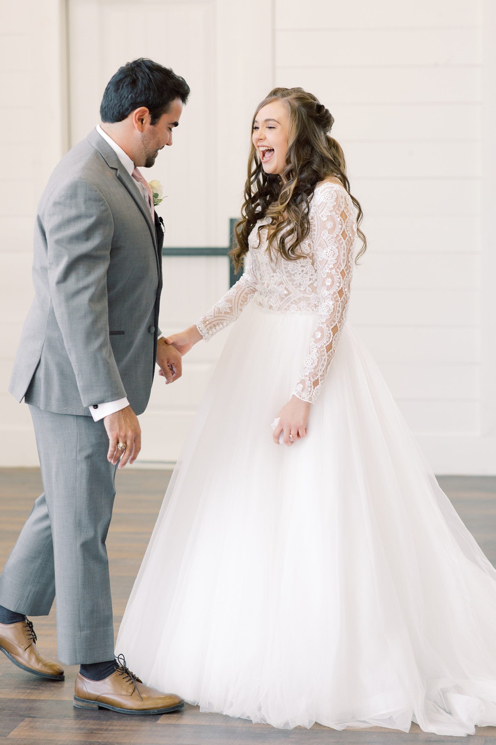 groom makes bride laugh during first look