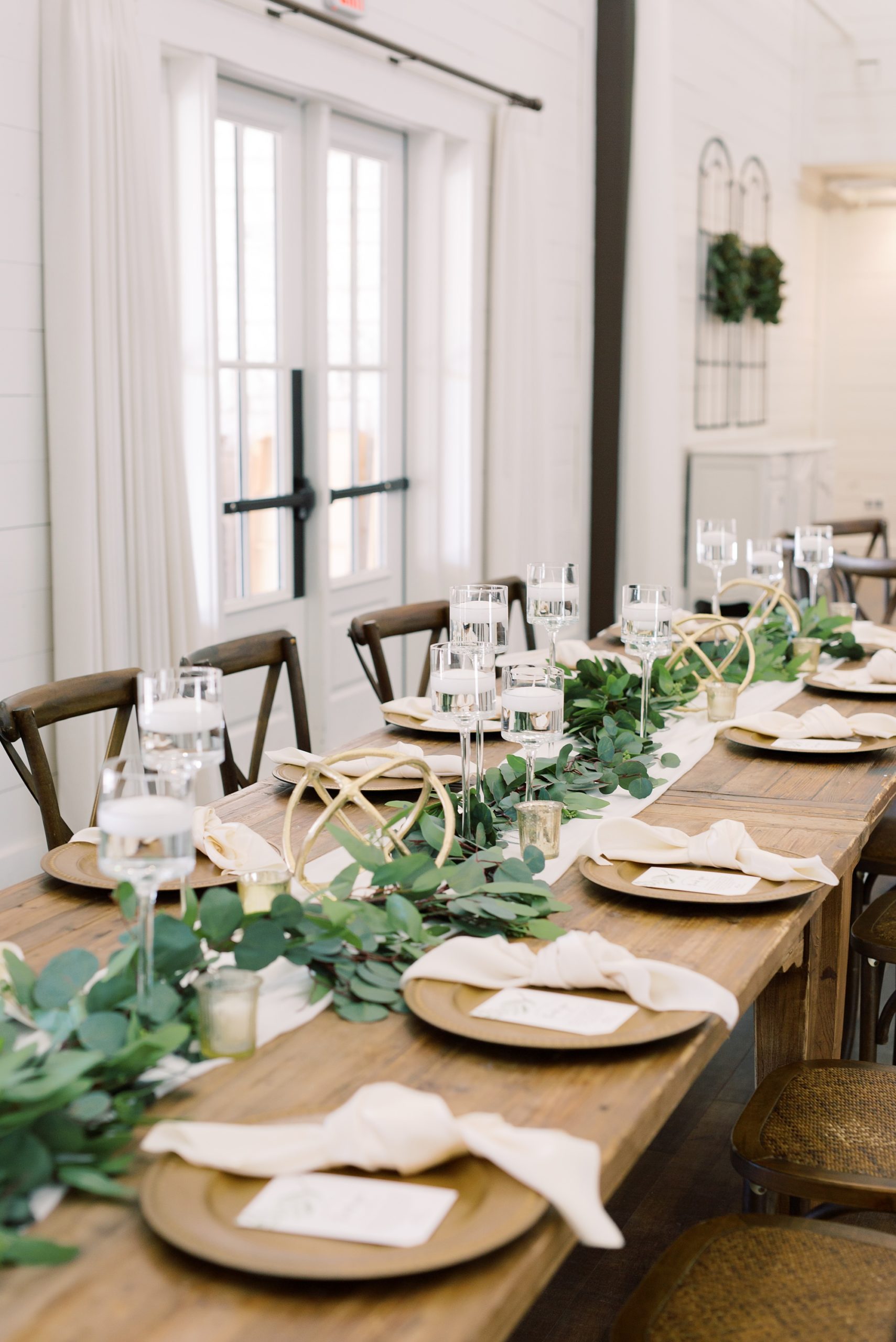 long tables with place settings and greenery table runners at HighPointe Estate