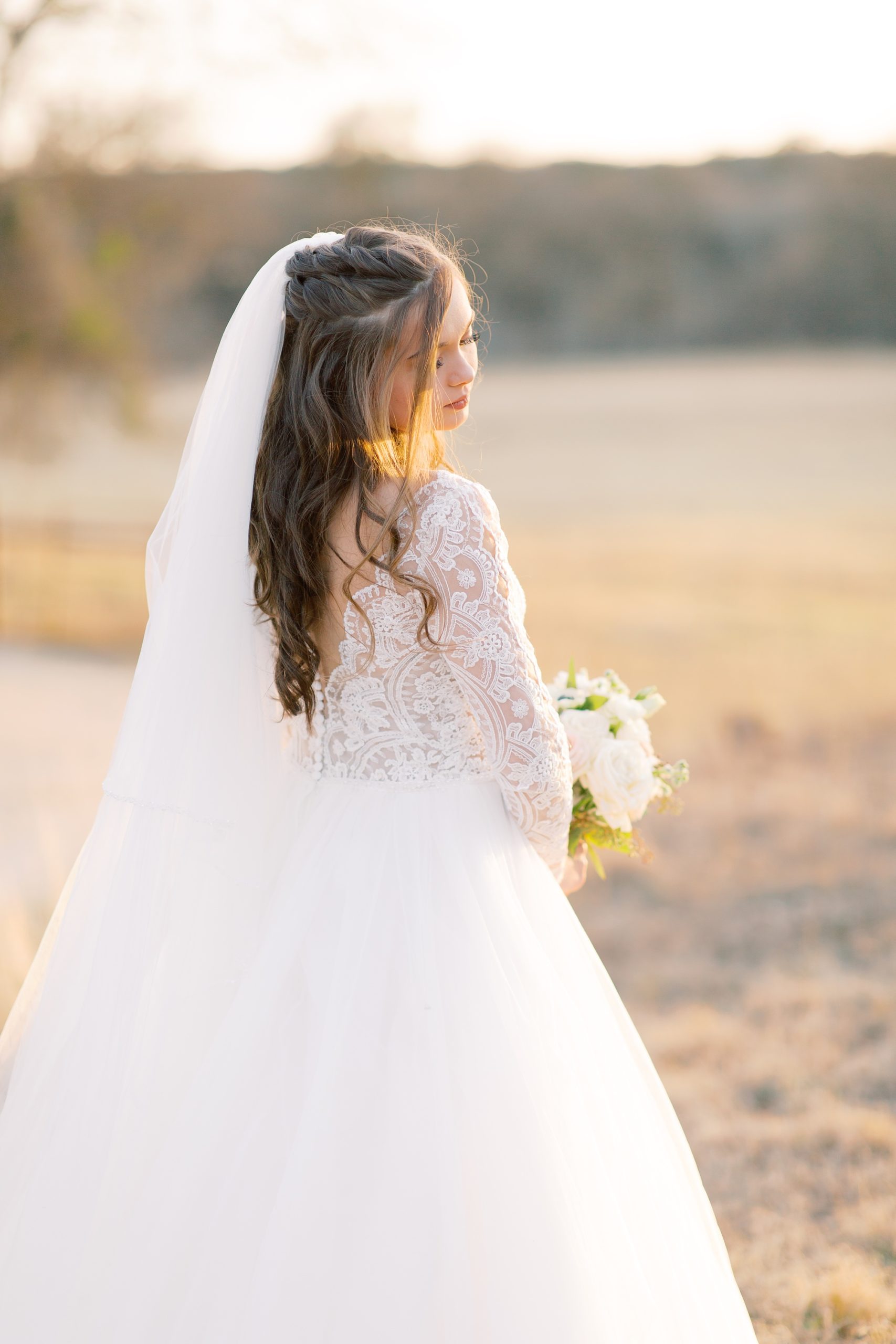 bride looks back over shoulder during bridal portraits at HighPointe Estate