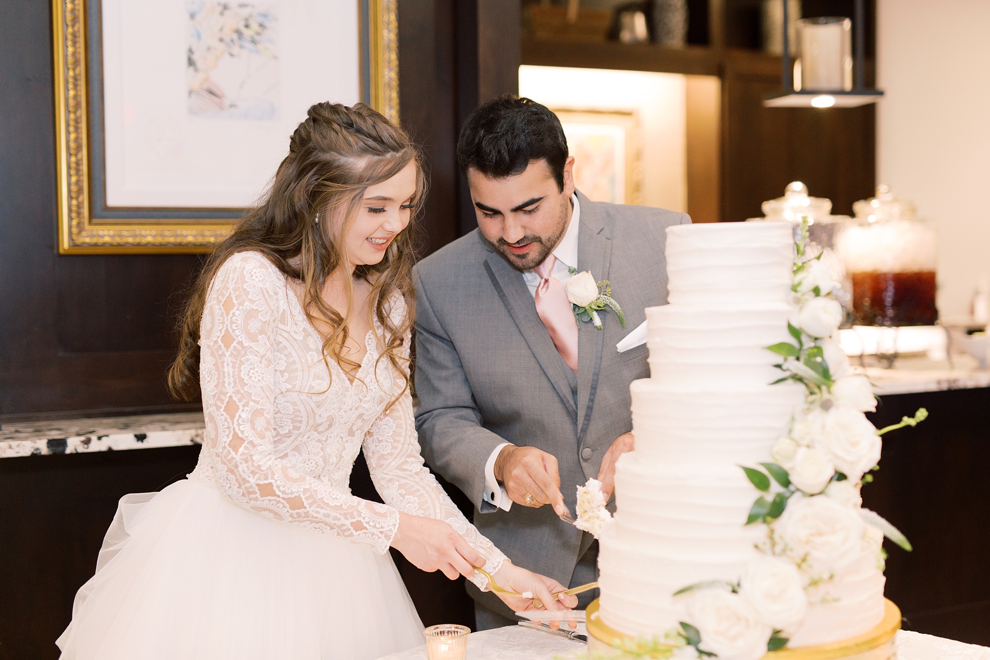 newlyweds cut wedding cake at HighPointe Estate wedding reception