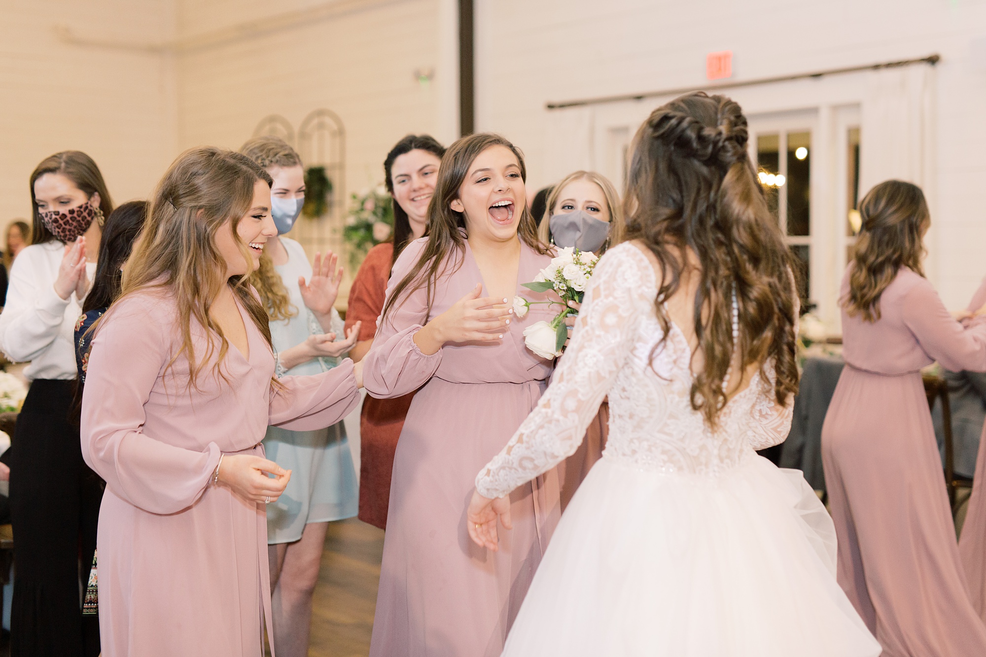 HighPointe Estate wedding reception bouquet toss winner laughs with bride