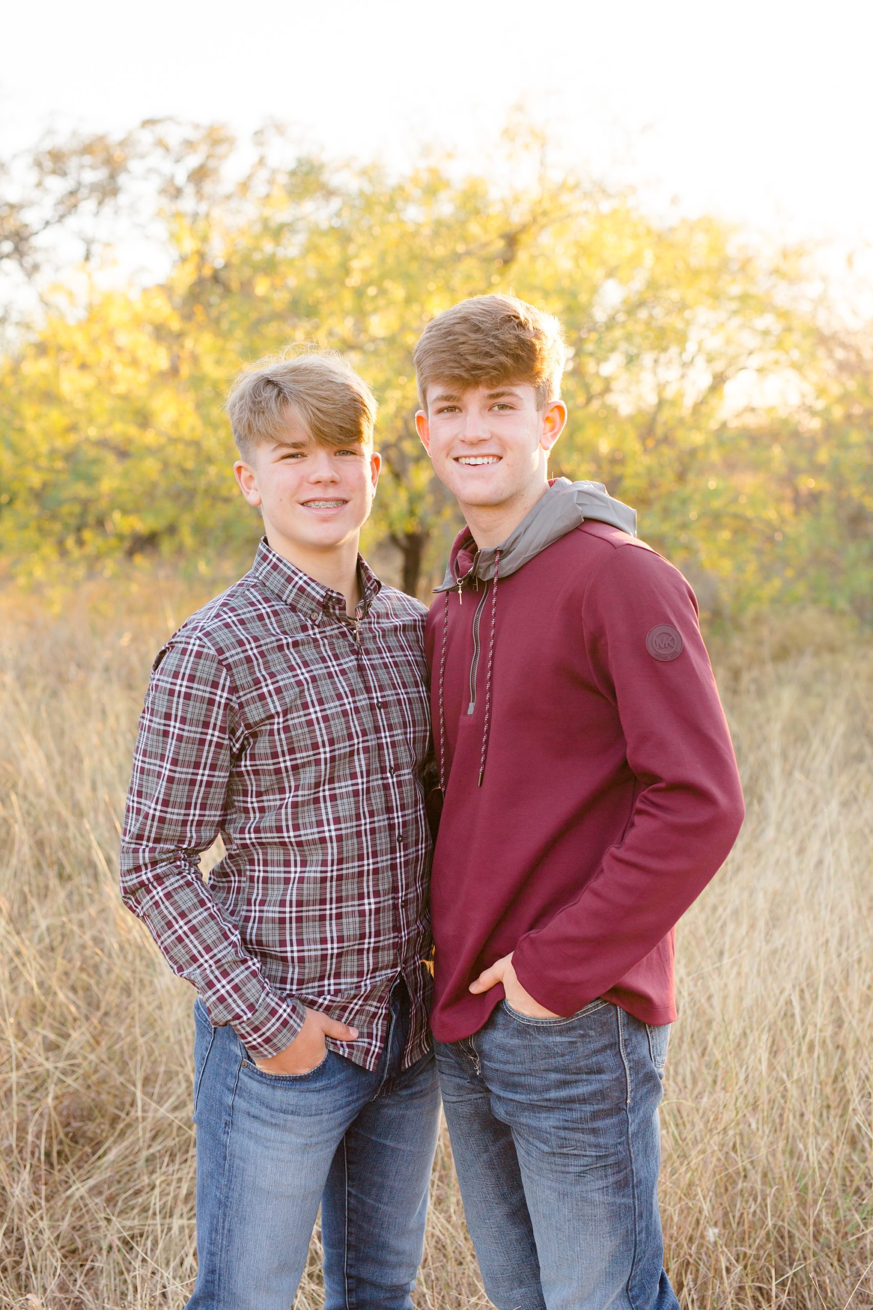 brothers hug during family photos in field at Murrell Park
