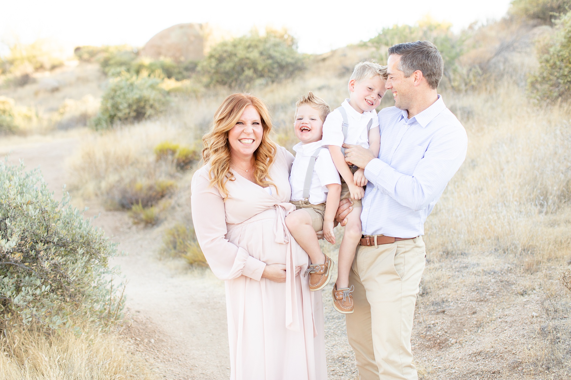 family with two boys poses during Scottsdale AZ maternity session