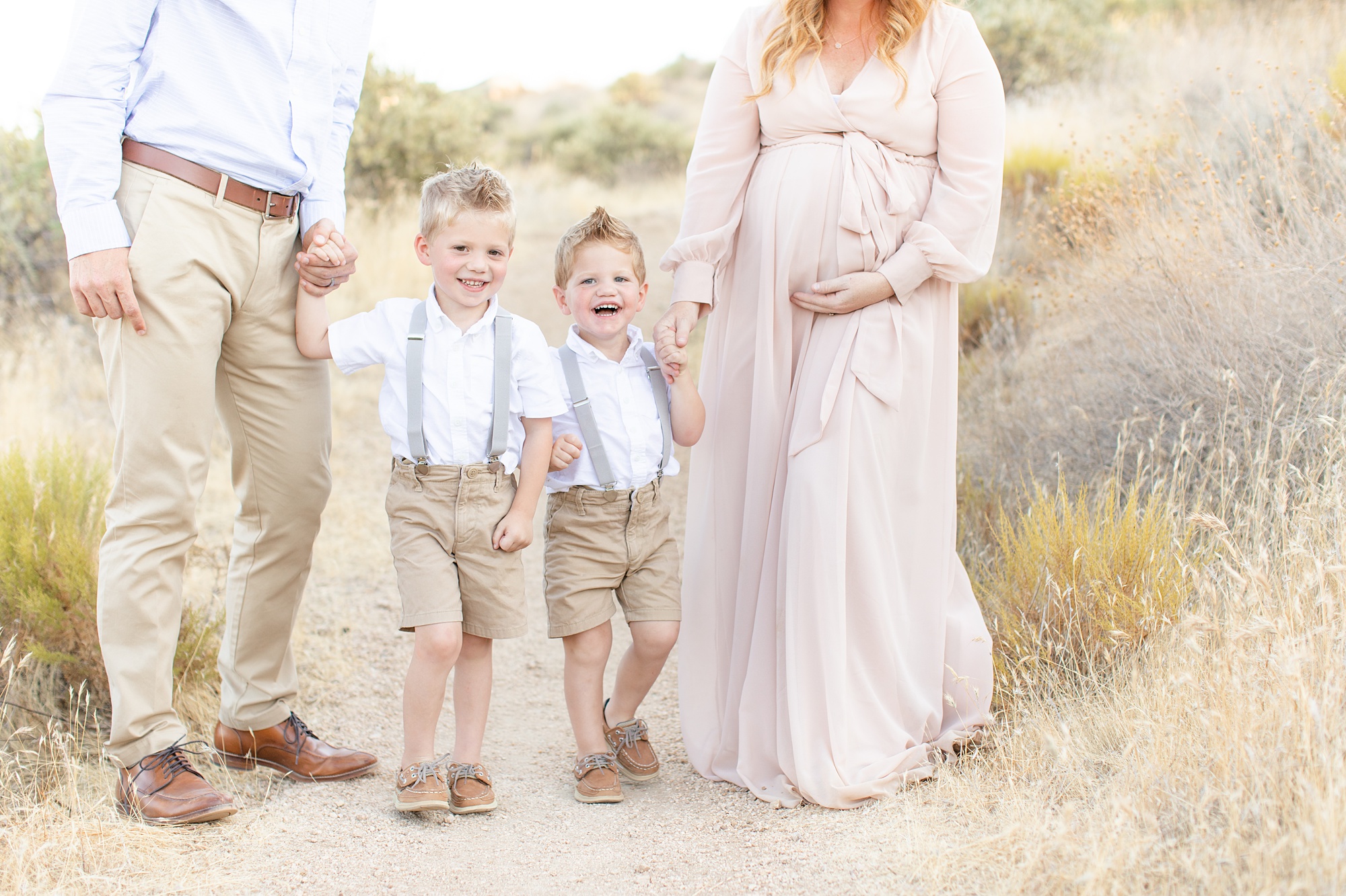 brothers hold parents hands during Scottsdale AZ maternity session
