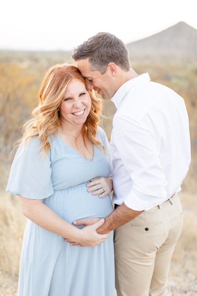 husband and wife pose together in desert during Scottsdale AZ maternity session