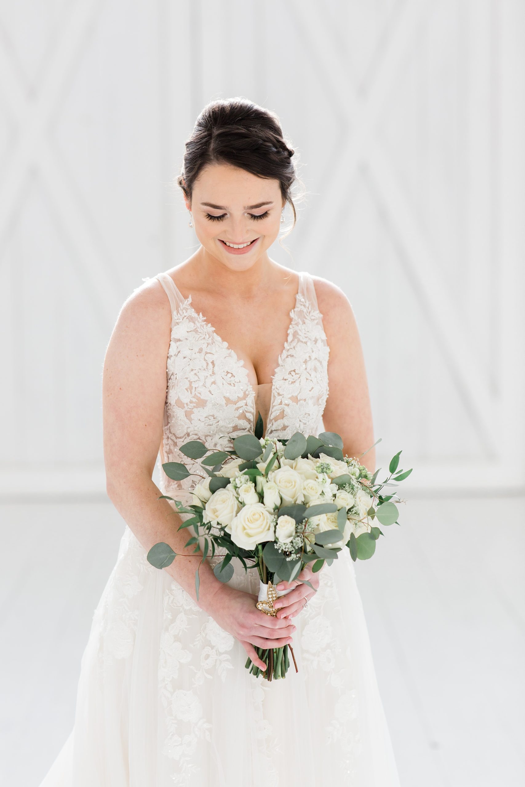 bride holds bouquet of white flowers during bridal session in Texas