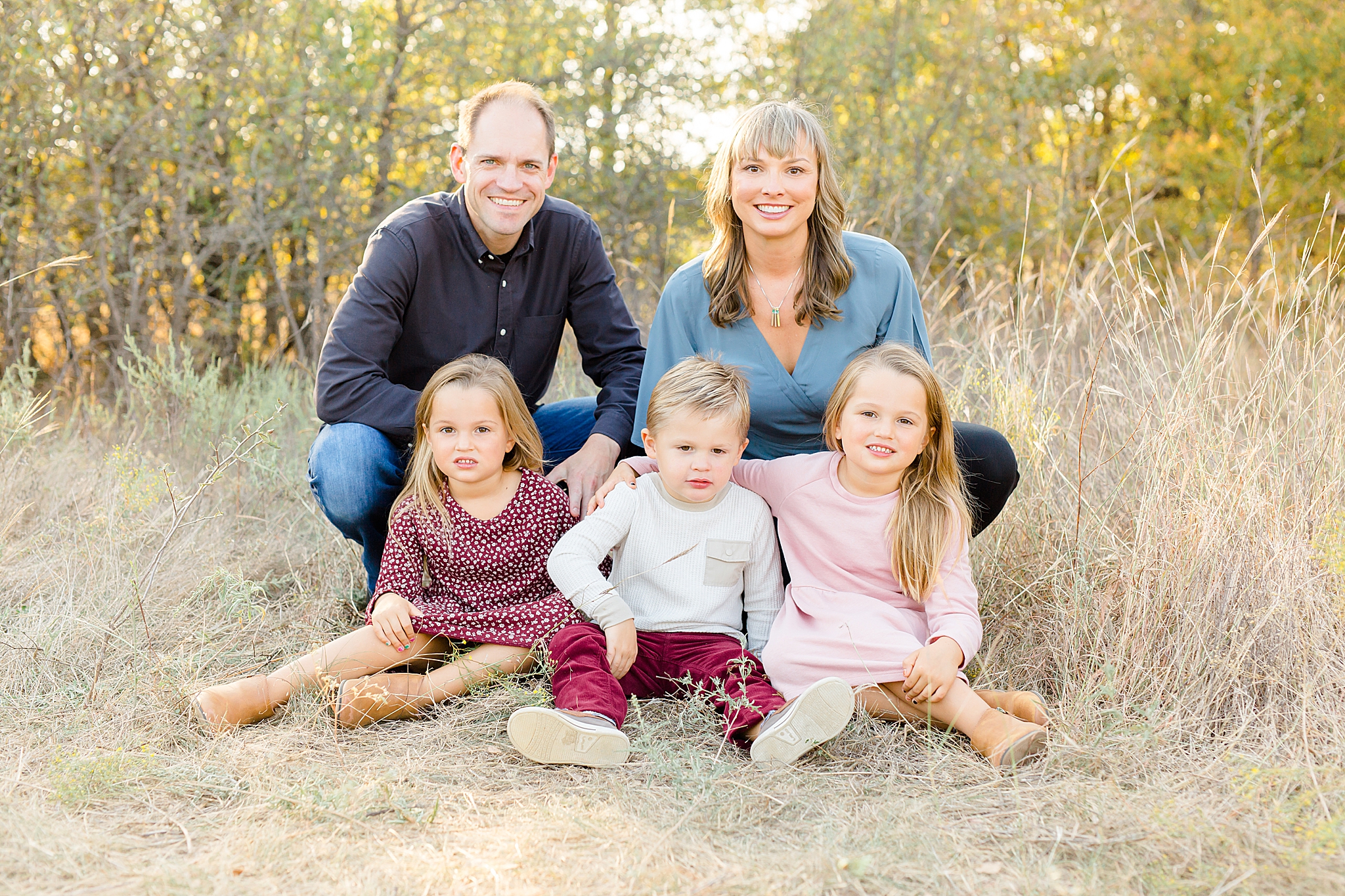 family of five poses in grass during Murrell Park family photos